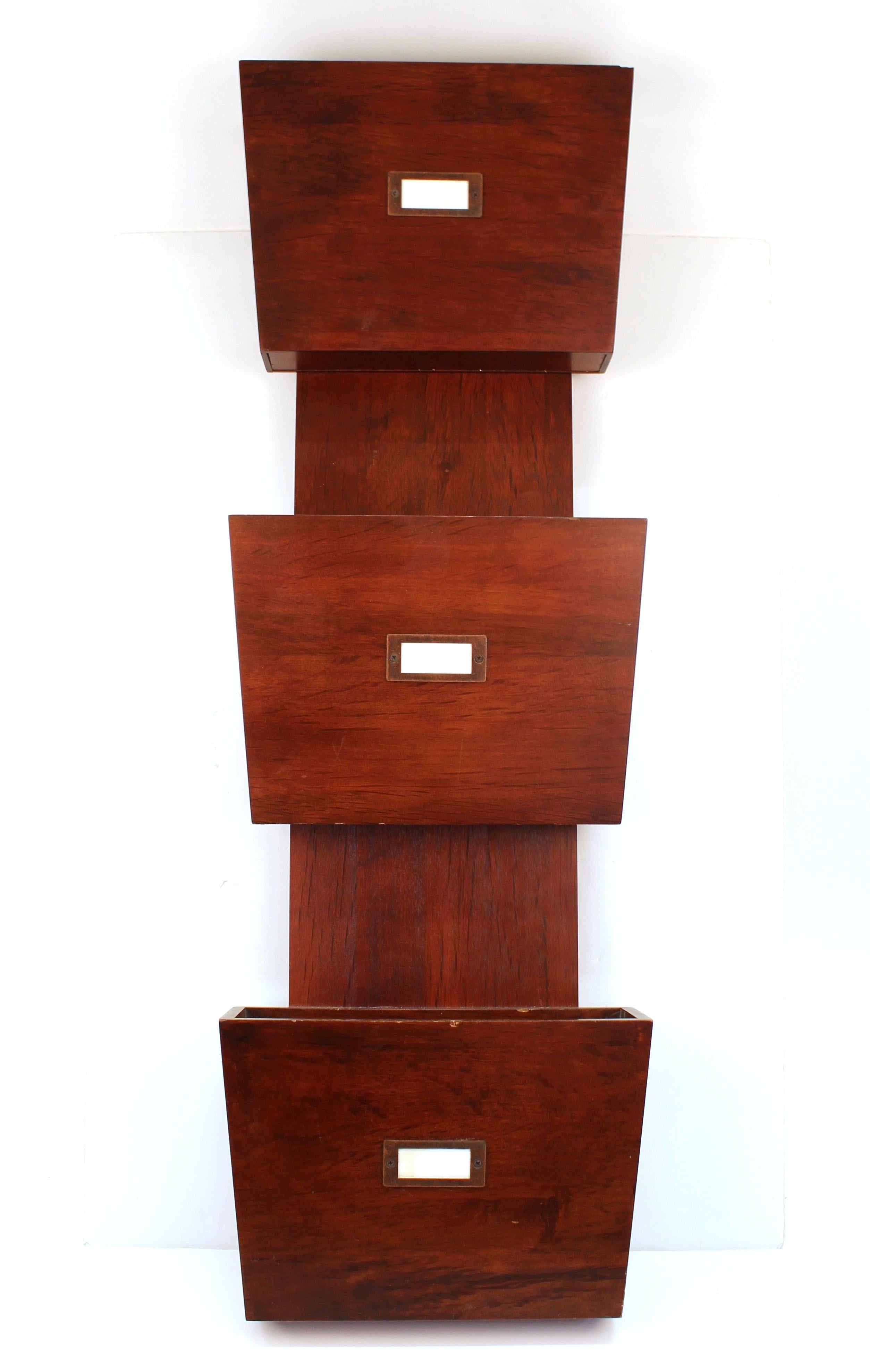 Mid-Century Modern style wall-mounted document holder in wood with three separate sections for documents, each one with a tag holder. In great vintage condition with some minor chips to the edges of the document containers.