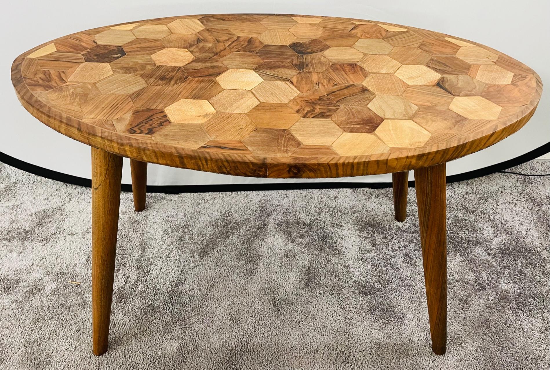 A Mid-Century Modern style coffee table featuring an oval shaped top and an exquisite hexagonal motifs. the table is made of birch wood and is light and easy to move around. The handmade Mid-Century Modern style will add style to any room and