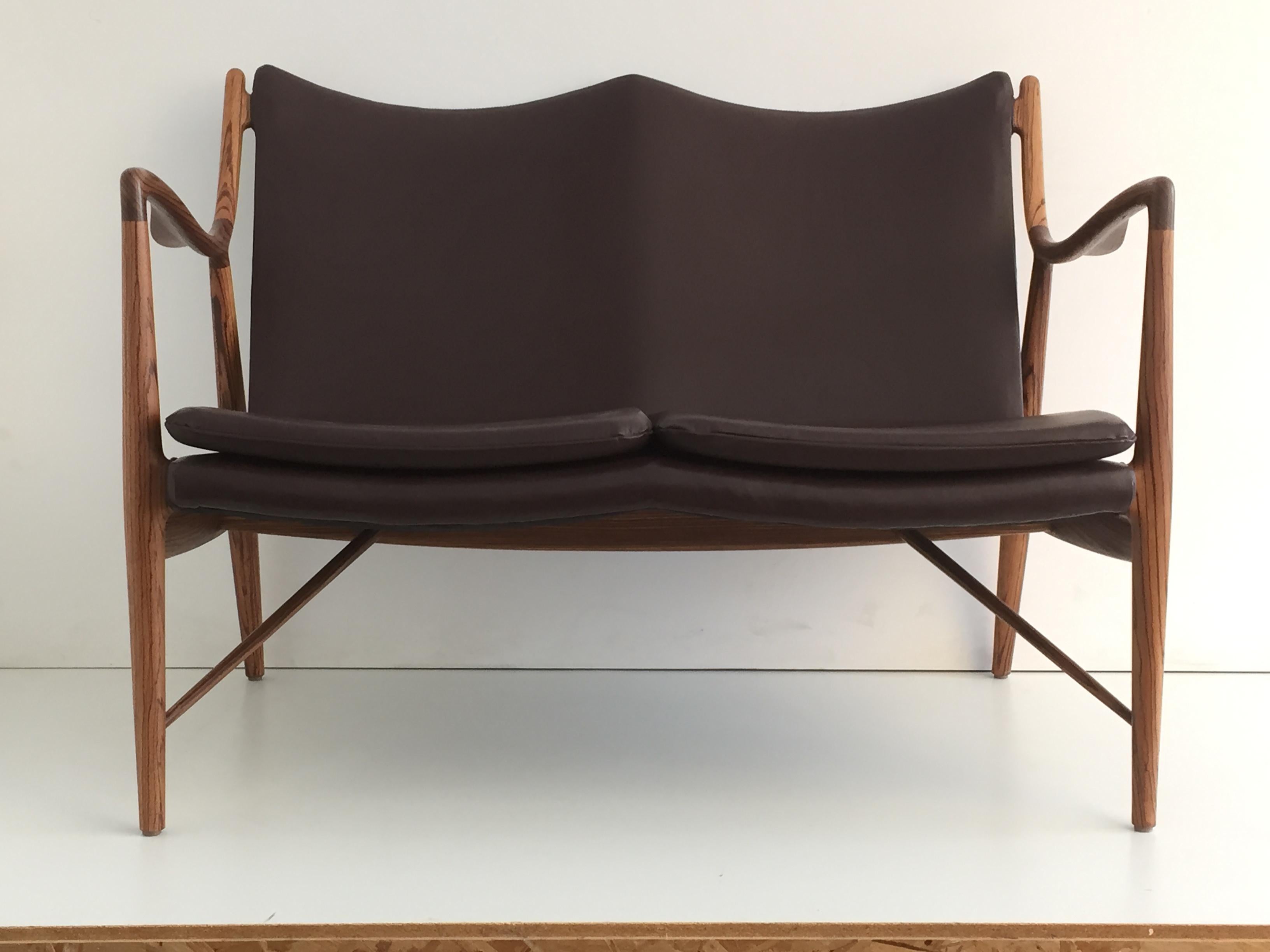 Mid-Century Modern style zebra wood settee in the manner of Finn Juhl. Made in 1990s in solid zebra wood and upholstered in dark brown leather.
