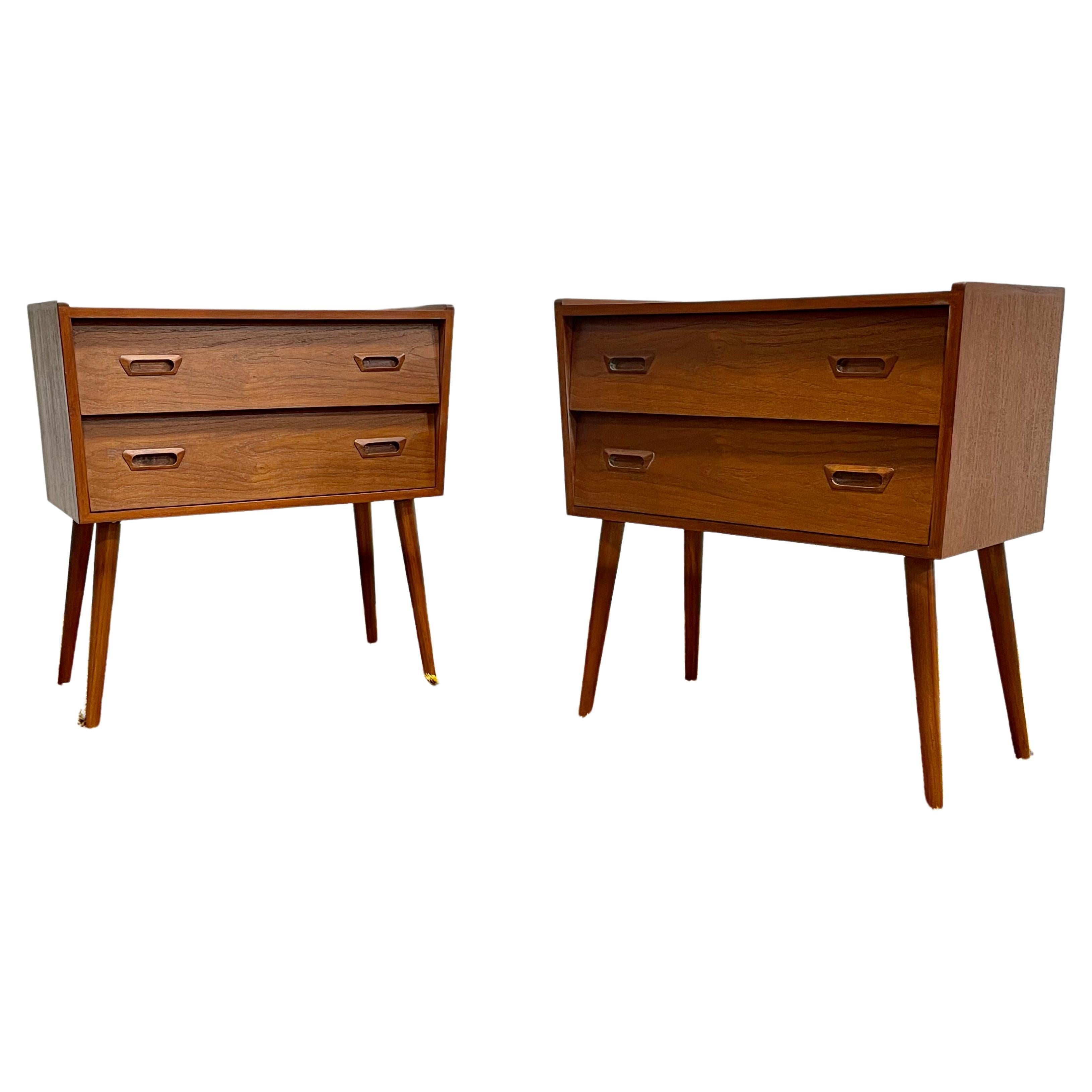 Pair of Mid-Century Modern styled teak nightstands. Gorgeous asymmetrical design featuring loads of design details including 'eyelid' handpulls, finished backs and long tapered legs. Two drawers for all your bedtime essentials. Excellent condition,