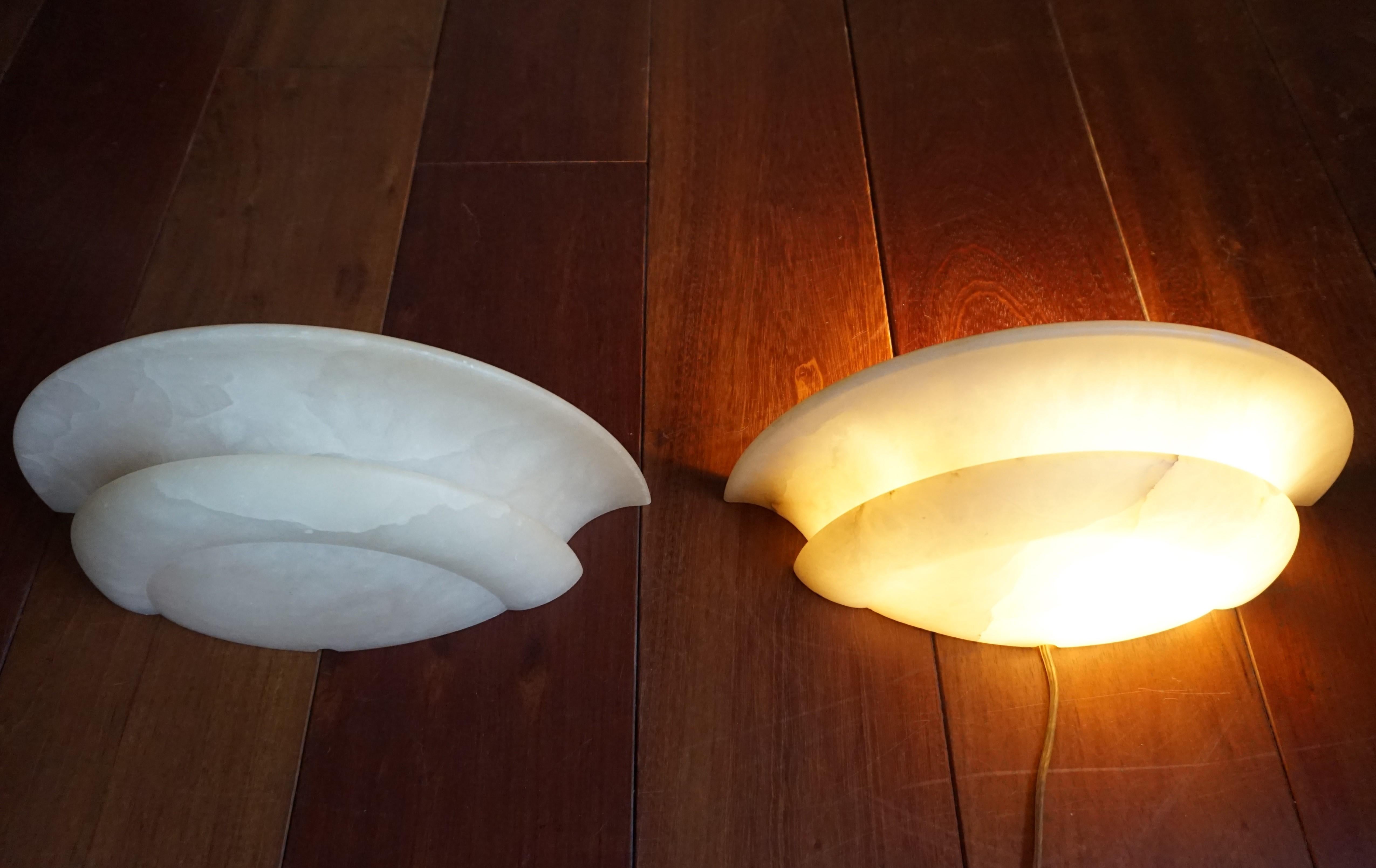 Wonderful shape, perfect size and excellent condition alabaster sconces.

This excellent condition pair of dish-shaped alabaster light fixtures for wall mounting will look great no matter where you decide to use them. They could grace the wall in