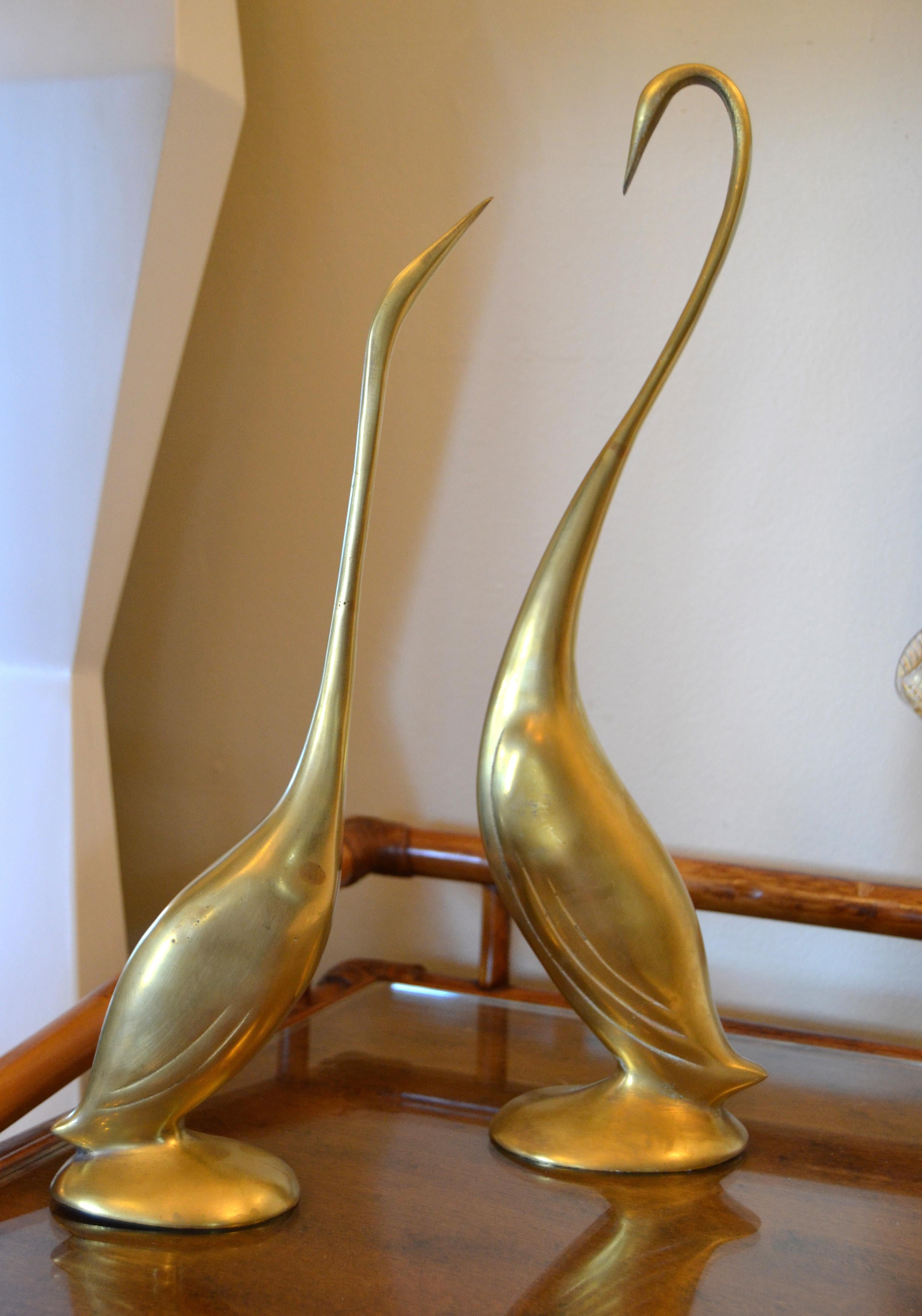 Mid-Century Modern gorgeous pair of stylized cast brass herons animal sculptures. 


 