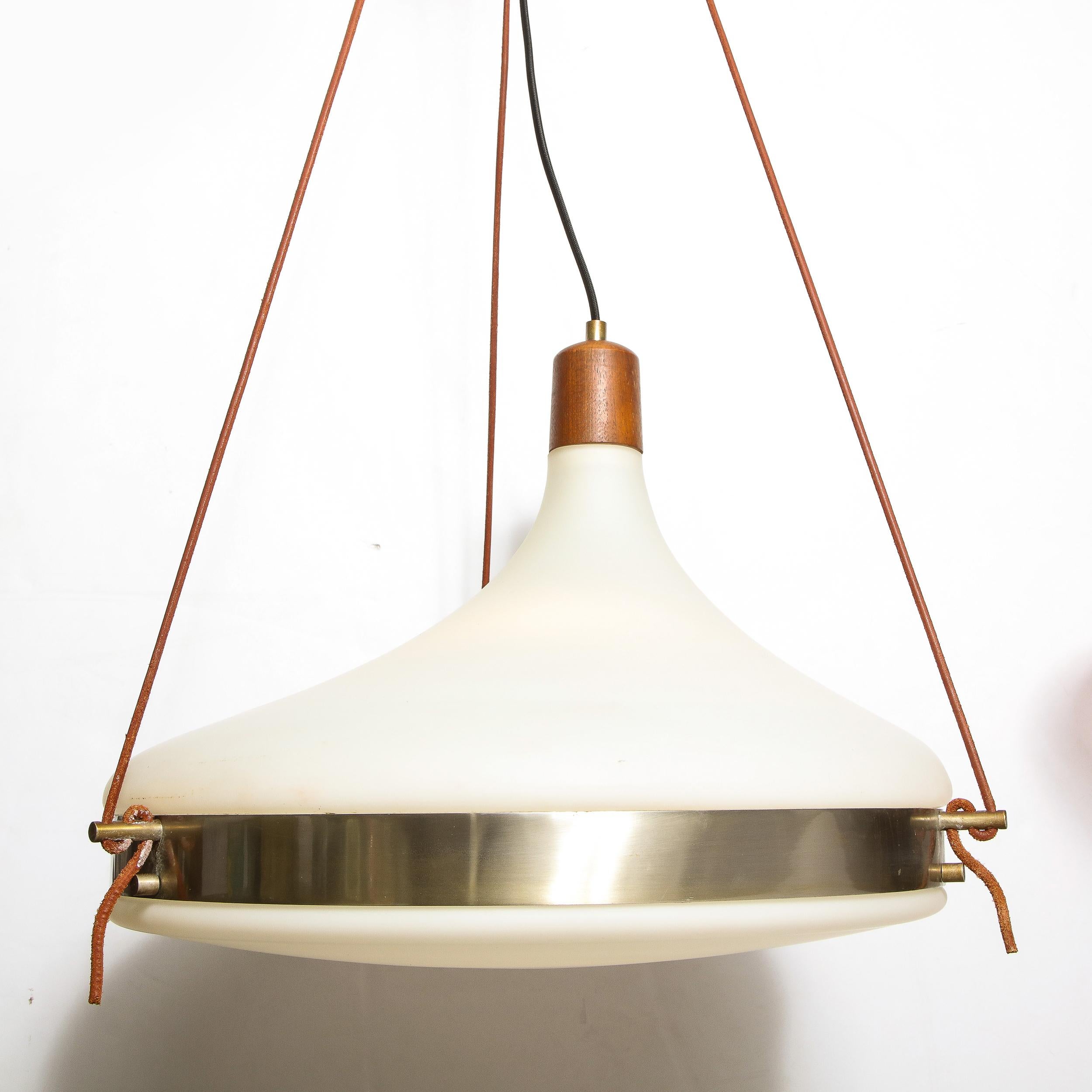 This refined Mid-Century Modern chandelier was realized in Murano, Italy- the island off the coast of Venice renowned for centuries for its superlative glass production. Executed in handblown white Murano glass, brass with tan leather supports, this