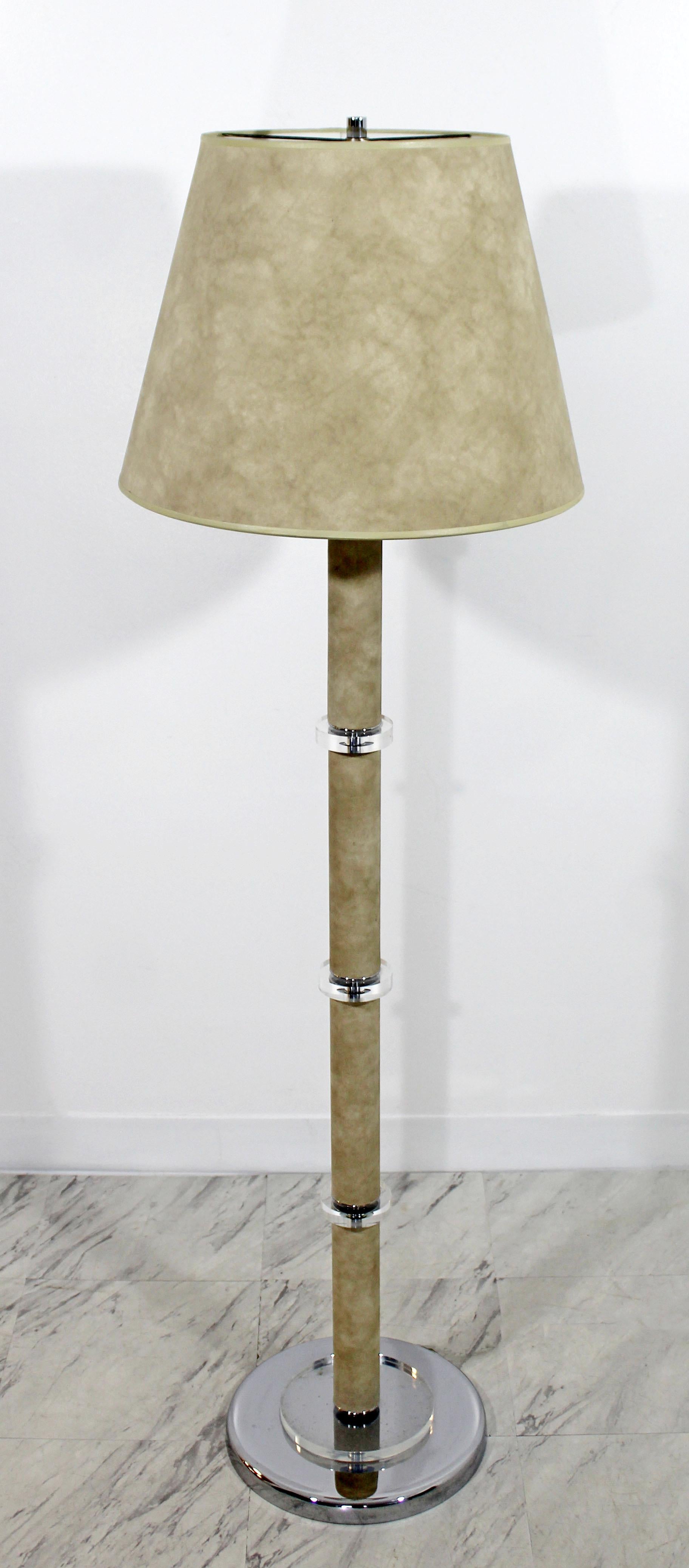 For your consideration is a magnificent floor lamp, with a chrome base, Lucite accents and wrapped in tan suede, in the style of Karl Springer, circa 1970s. In excellent condition, despite some dirt caught between the Lucite and chrome base. The