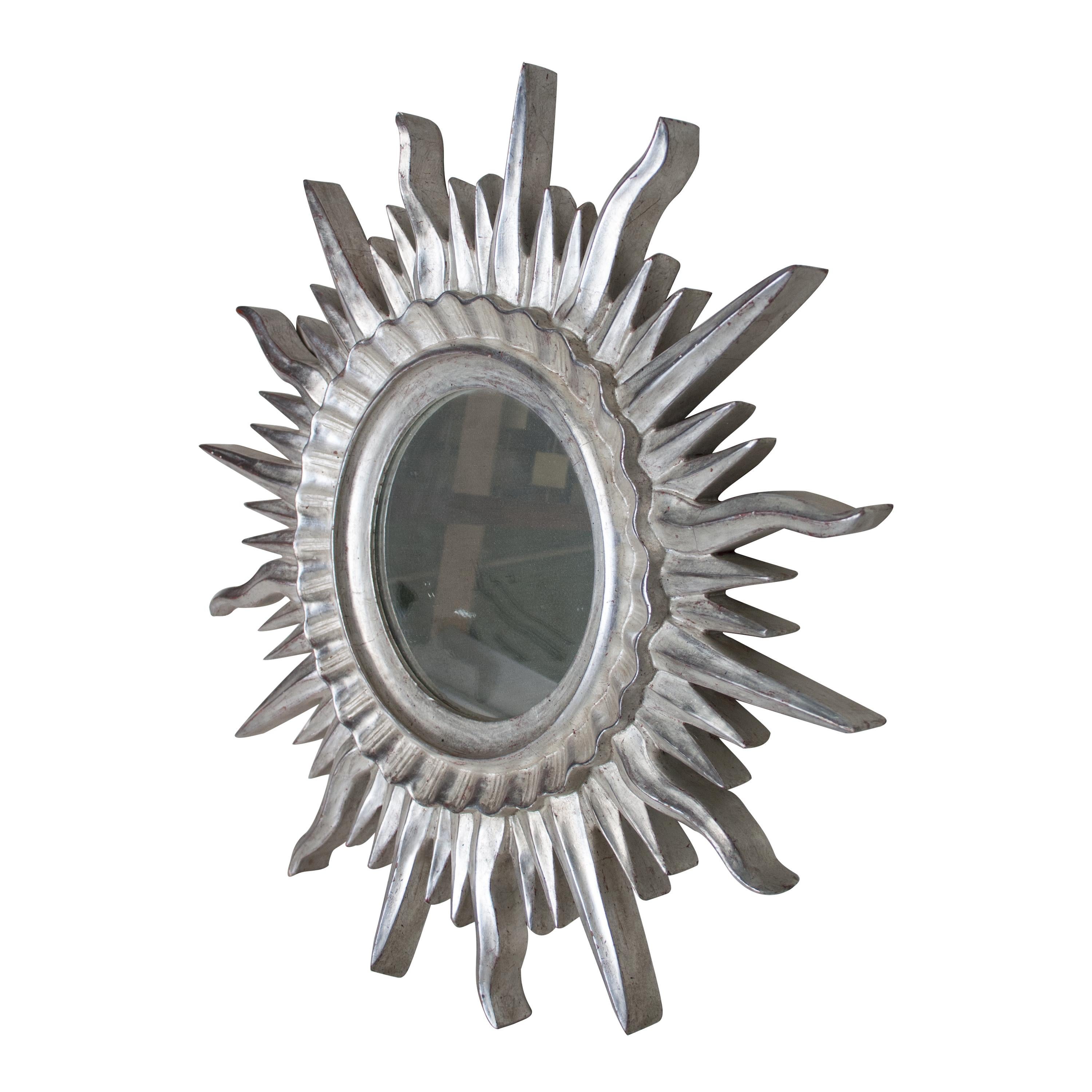 French mirror in the form of sun carved by polychrome hand finished in a silver bath.