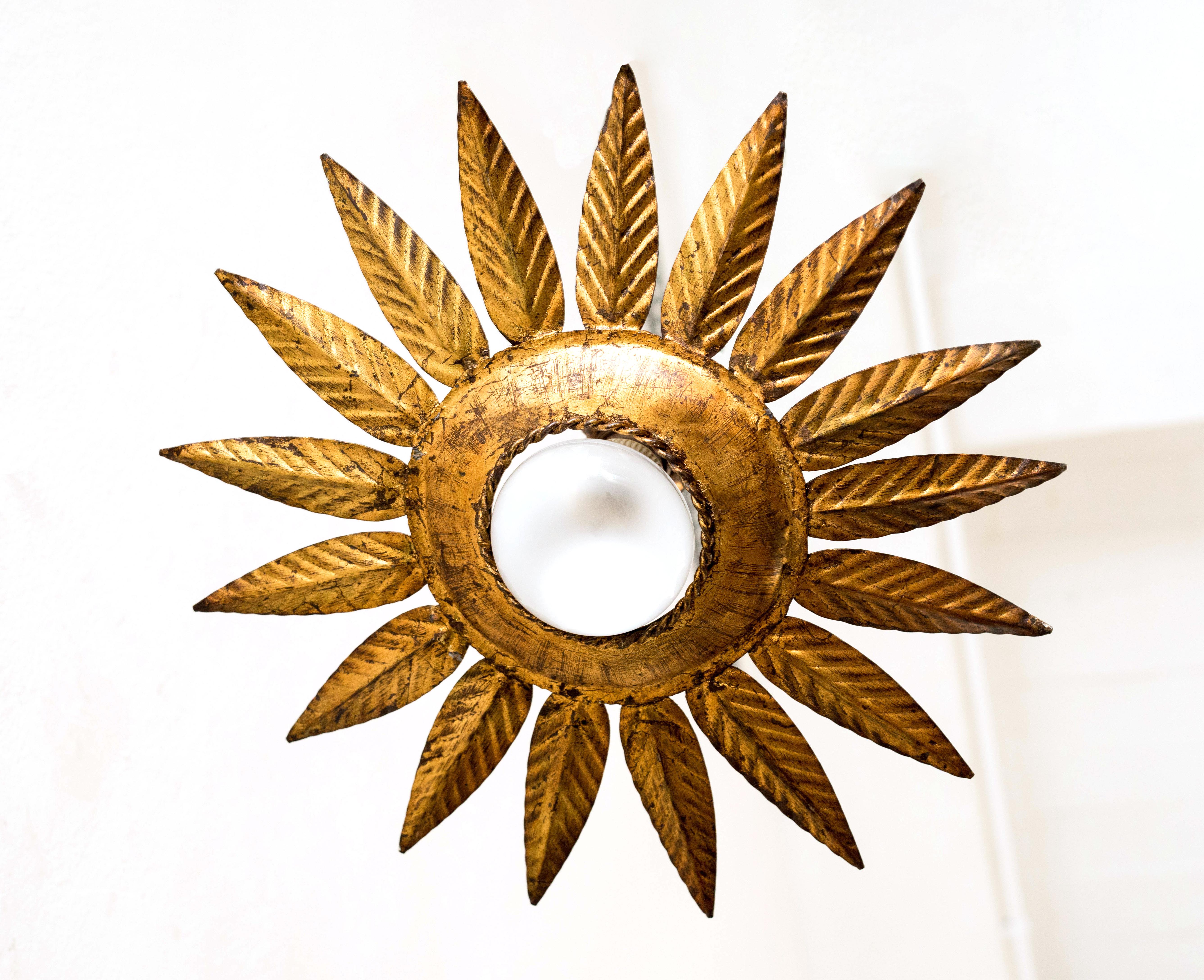 Behold the enchanting Mid-Century Modern sunburst brass pendant lamp, a dazzling relic from the creative era of 1960. Originating from the artistic hands of an unknown designer, this radiant piece was traditionally crafted in the heart of France,