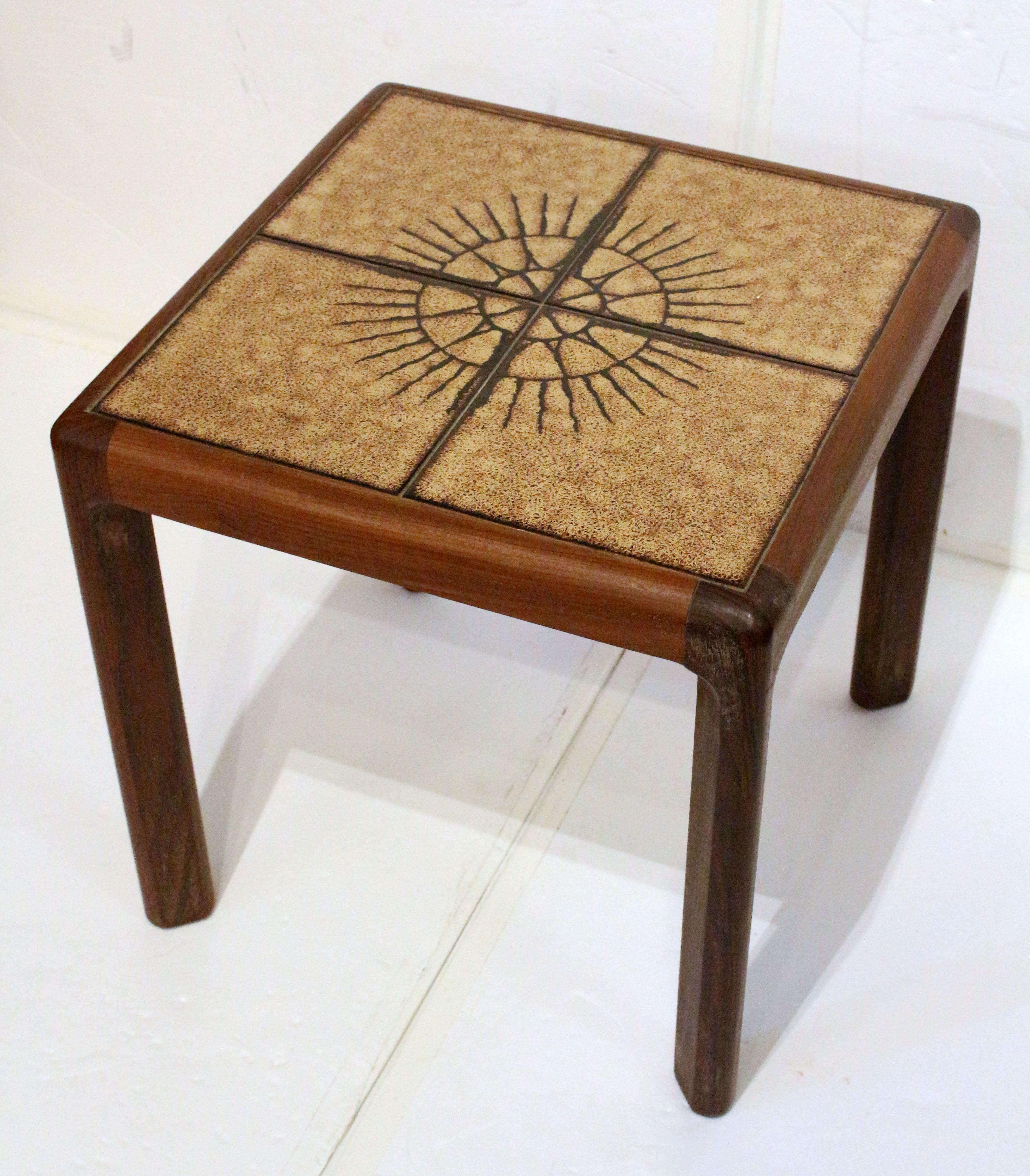 Mid century modern tile top side table. The beige & black tiles forming a sunburst. Stylish wooden table structure. 17 1/4