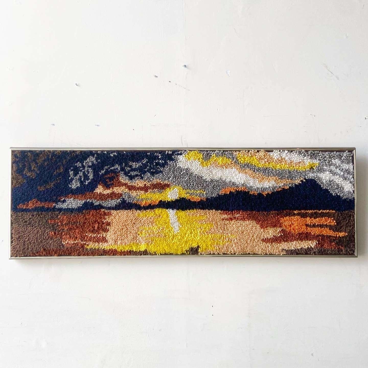 Exceptional mid century modern framed textile art. Features a sunset over the maintains in the distance.
