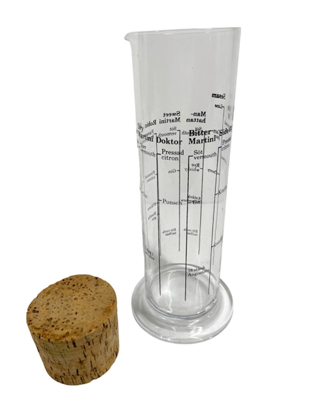 Mid-Century Modern Swedish cocktail shaker of cylindrical beaker form on a disk foot with cocktail recipes in black graphics (in Swedish) and with a large cork stopper.