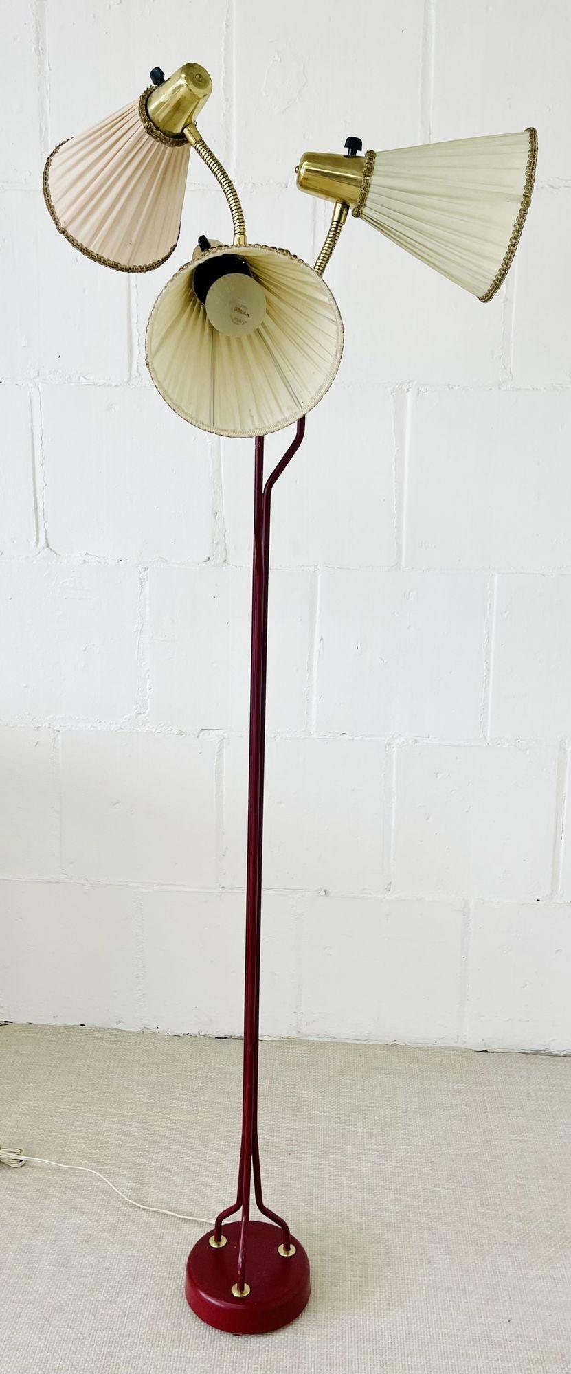 Mid-Century Modern Swedish Designer, Three-Light Floor Lamp From Ekilstuna Elektrofabrik, Model 145
 
Jacques Adnet style. A sleek and stylish tall or floor lamp in fire engine red finish with bronze attachments in a column style supporting three