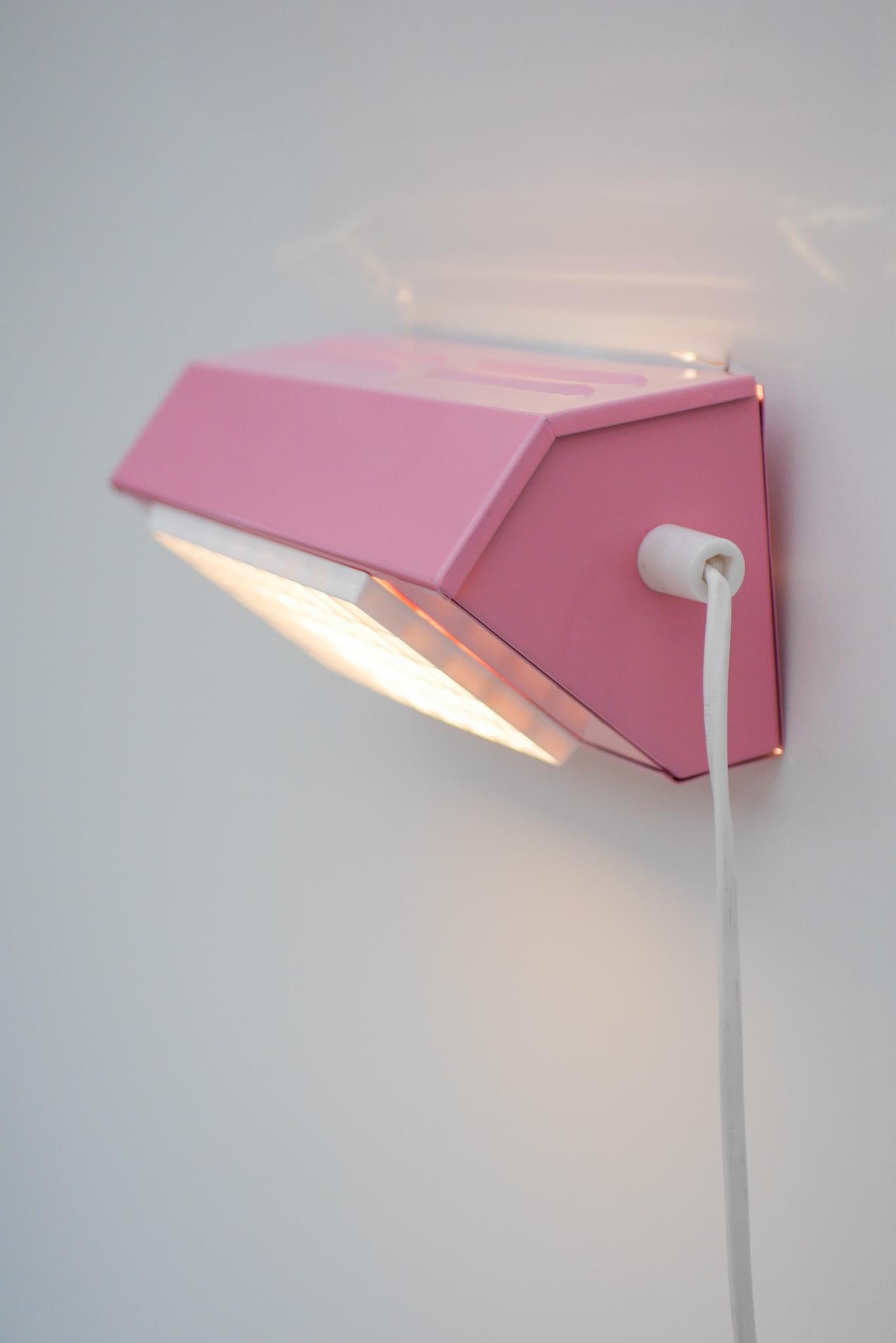 A Vintage bedside sconce or wall lamp, in a very pink color in an angular brutalist blocky design from the 1970s. Made by Swedish company Markaryd/ Elidus, and it is attributed to Hans Agne Jakobsson one of Sweden's most talented designer. Made from