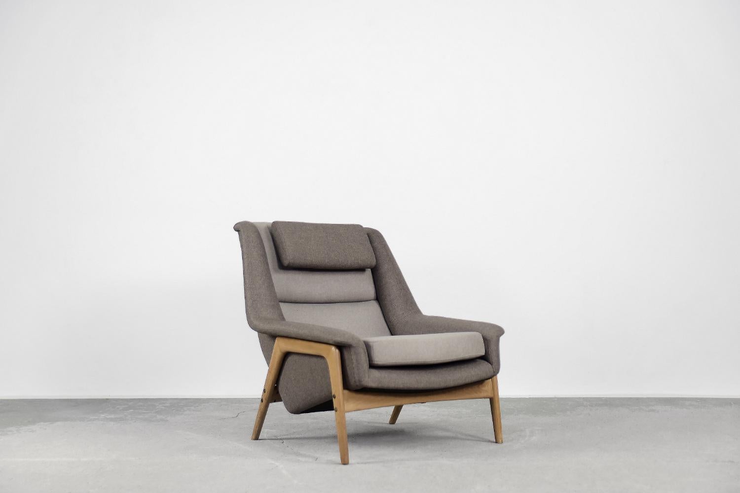 This modernist armchair was designed by Folke Ohlsson for the Swedish manufacture Dux, Ljungs Industrier AB during the 1960s. The frame of the armchair was made of solid beech wood. The high backrest, spacious seat and armrests have been profiled.