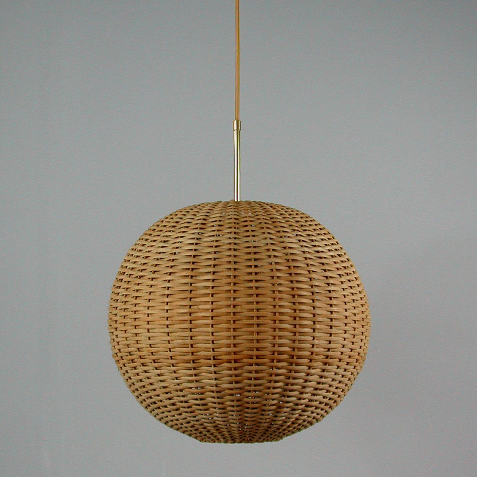 This awesome globe pendant was designed and manufactured in Sweden in the 1960s. It features a wicker lampshade with brass hardware. The lamp has got a very nice warm light when lit and looks amazing. This lamp requires one E27 bulb up to 100 watt