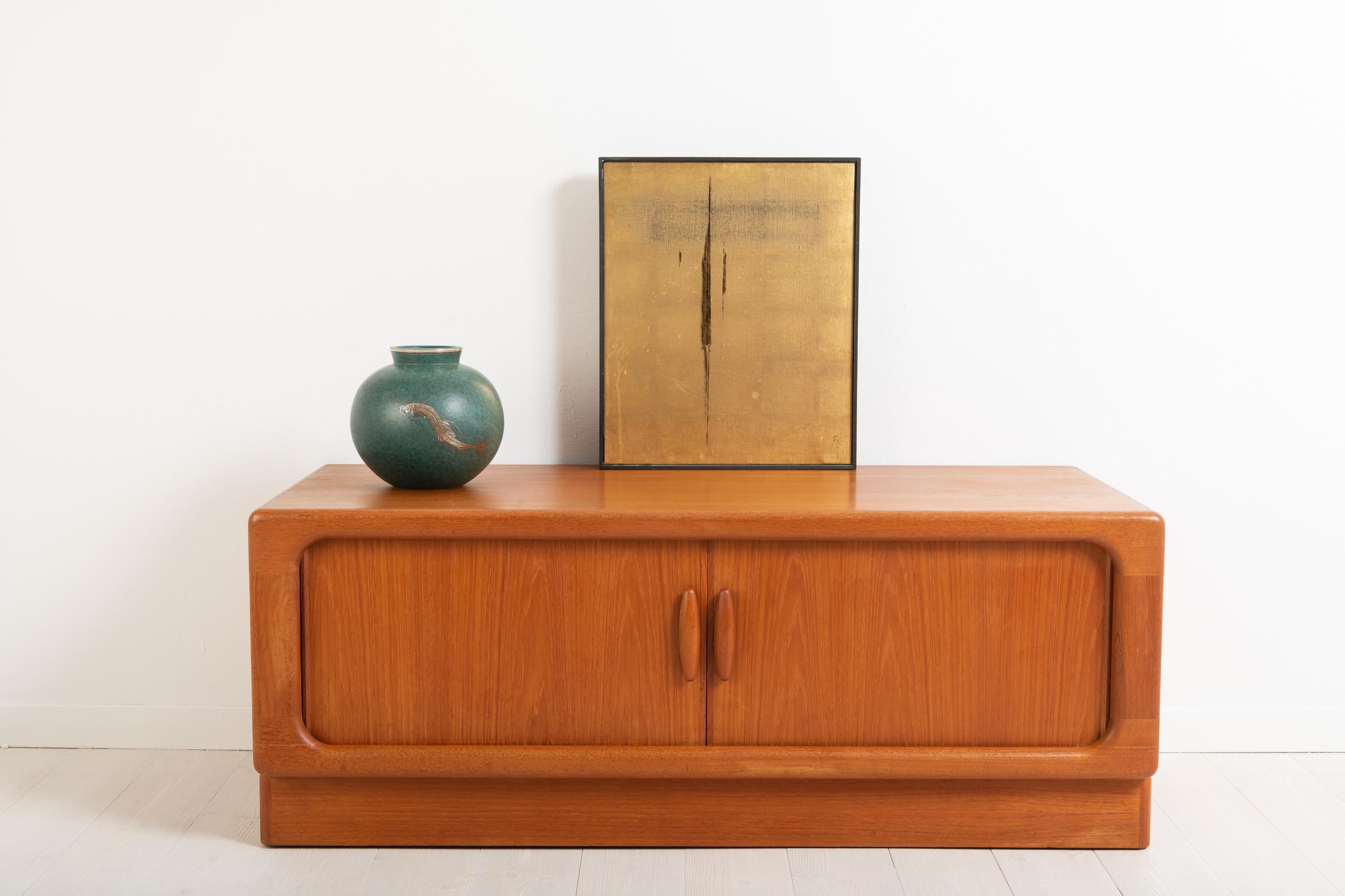 Sideboard in teak made by Dyrlund in Denmark. 1960s sliding doors. The sideboard is made from teal and marked with a label. Good vintage condition consistent with age and use. Minor traces of wear.