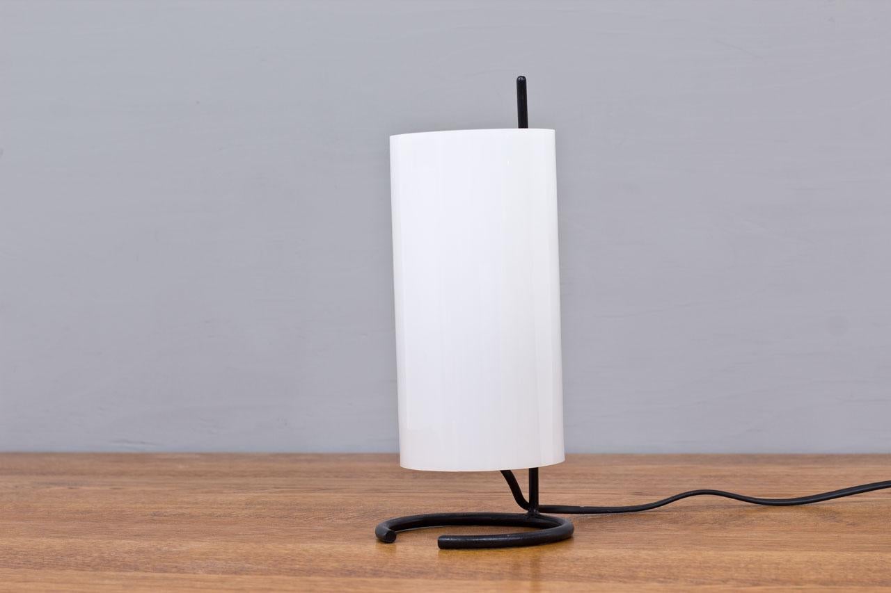 Rare  model of table lamp manufactured by AB Luco in Göteborg, Sweden during the 1950s.  Minimalist lighting fixture made from acrylic diffuser with a metal structure. New electricity in working order with light switch on the cord.
    