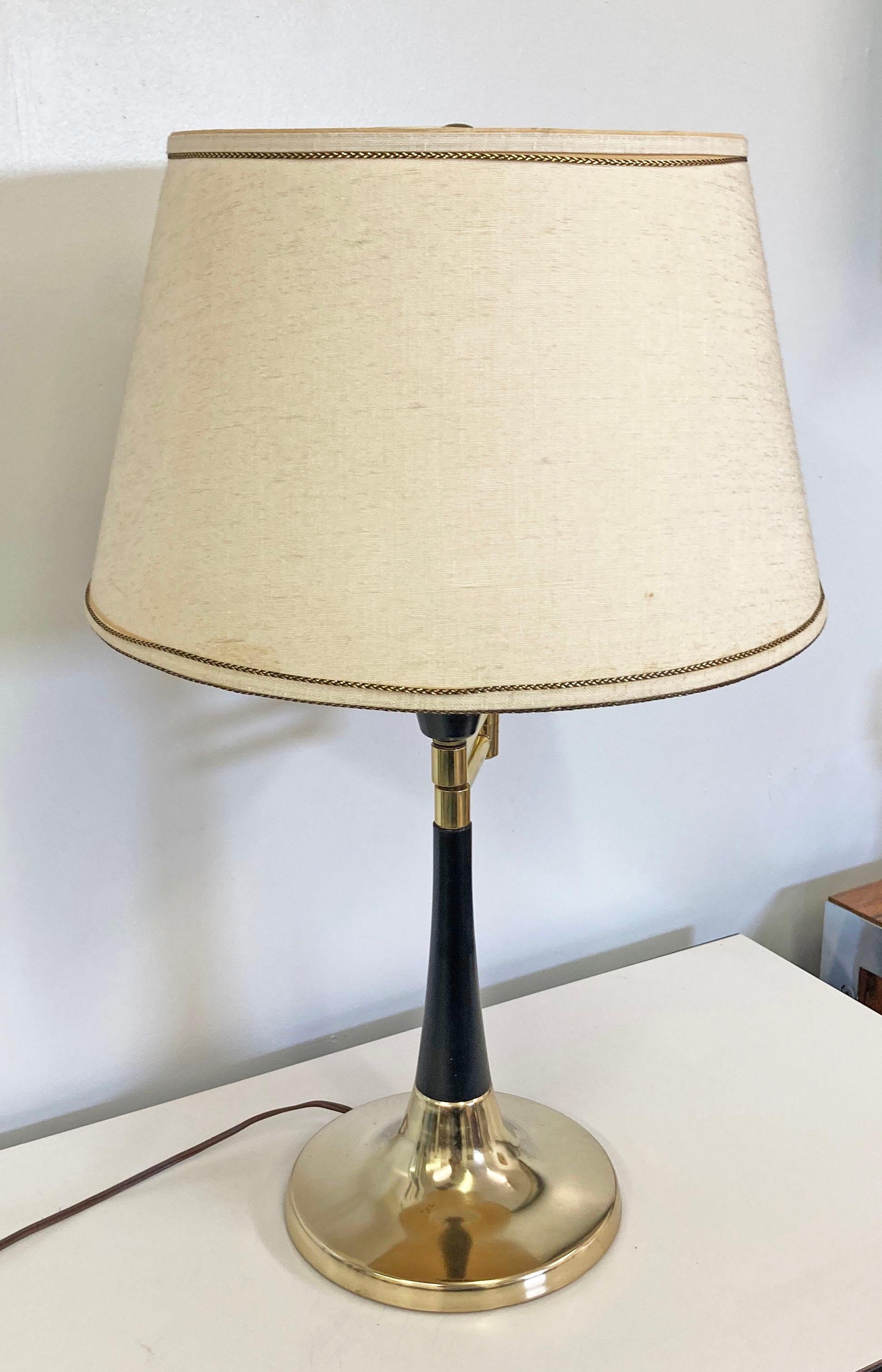 Offered is a vintage Mid-Century Modern table lamp, featuring a brass base with a swing arm. Has a diffuser attached as well. Lighting has been tested and is in working condition. In good condition with some age wear including surface wear/marks on