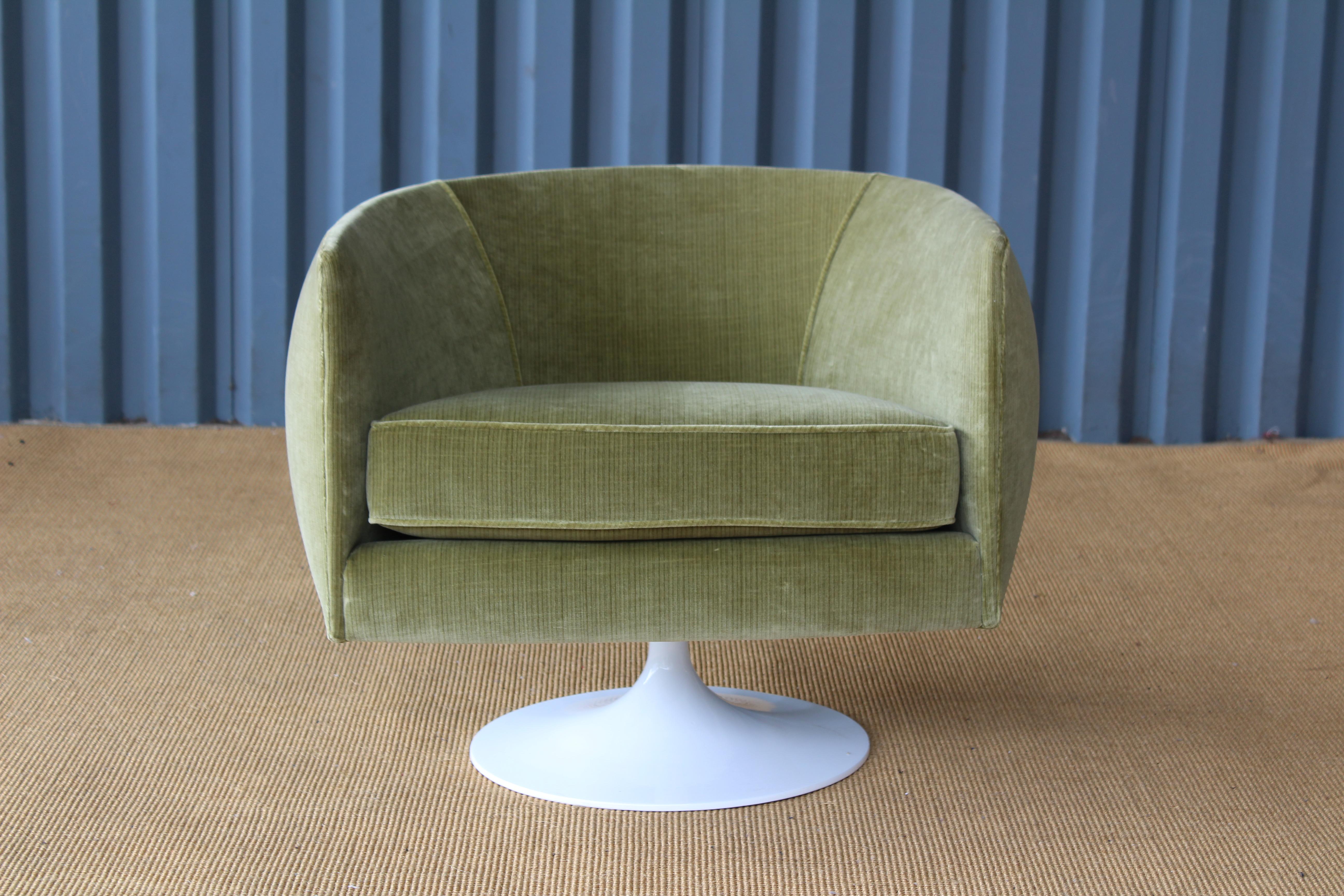 Mid-Century Modern armchair on a swivel base. This chair has been reupholstered in new green striped velvet. The base has been professionally powder-coated white. Includes a small removable lumbar pillow.