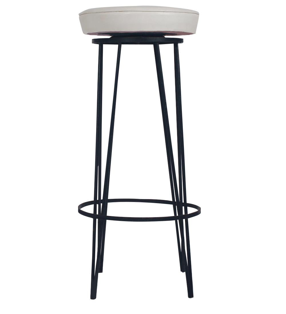 A super cool retro set of bar stools after Frederick Weinberg. These stools feature black iron hairpin legs with swiveling seat in original white Naugahyde.