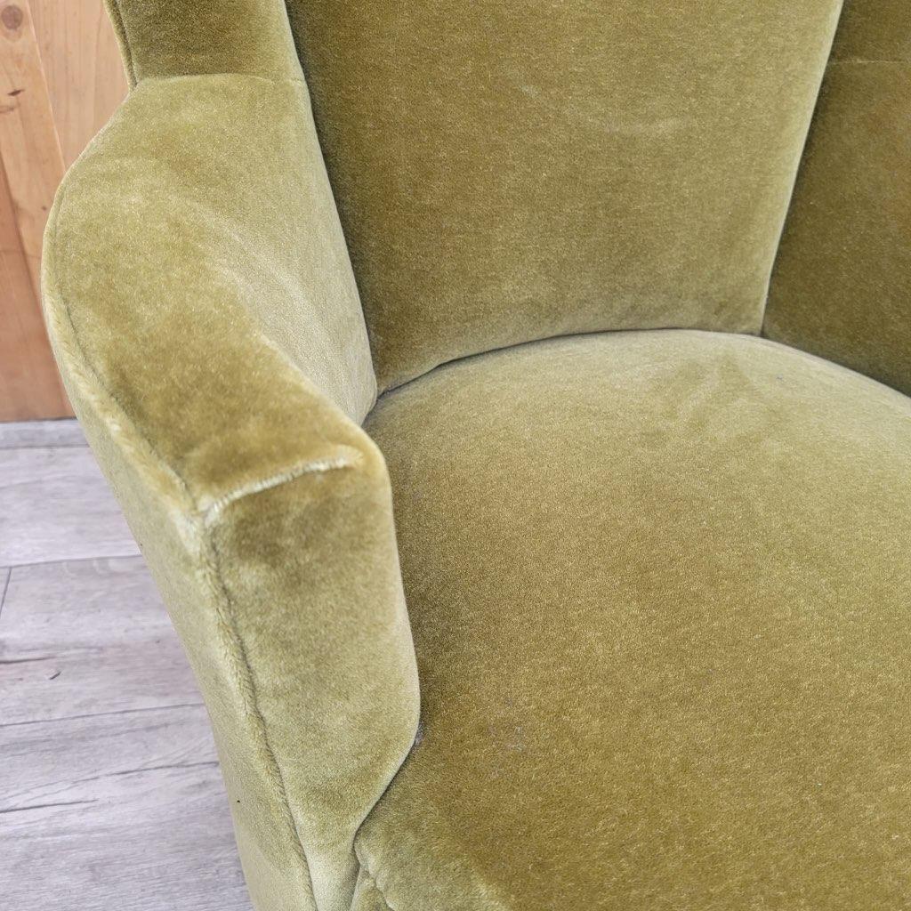Mid-Century Modern swivel barrel back lounge chair newly upholstered in a high end olive green plush Italian mohair.

Simple and classic, the chair is a modern version of the classic tub chair, featuring a smooth-gliding swivel in a compact