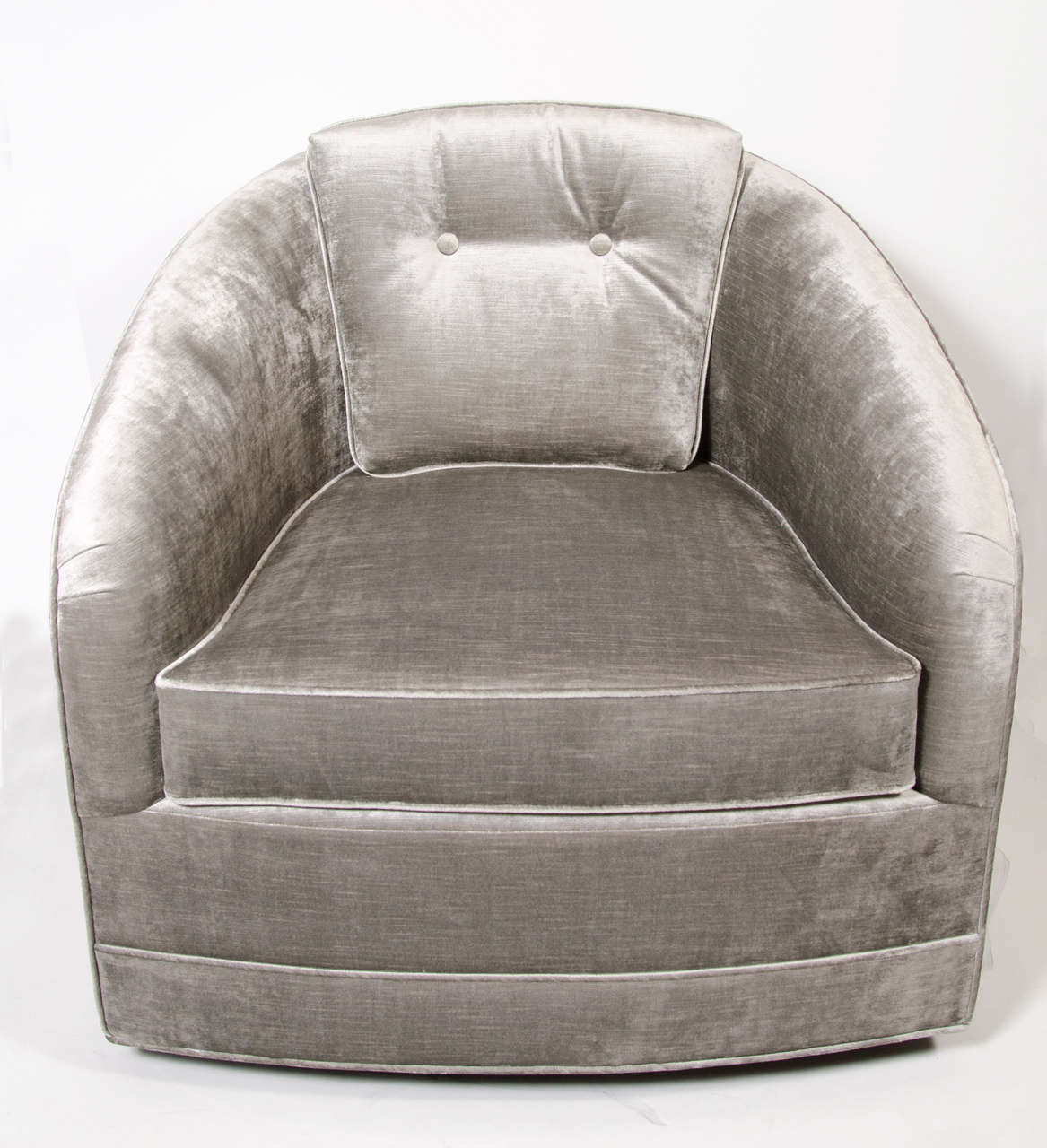 This stunning and elegant Mid-Century Modern swivel chair was realized, circa 1970. It features button back detailing, removable seat cushions and piping embellishments throughout. With its elegant proportions, clean modernist lines and neutral