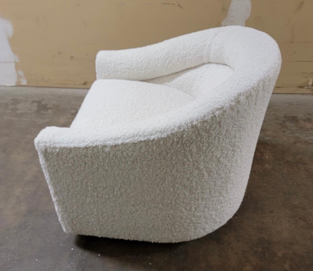 A stunning curved form barrel back swivel chair, circa 1970s by Jalen which was a small custom manufacturer. The chair has been newly reupholstered in a boucle faux shearling fabric which gives it not only a luxurious look but a comfortable feel
