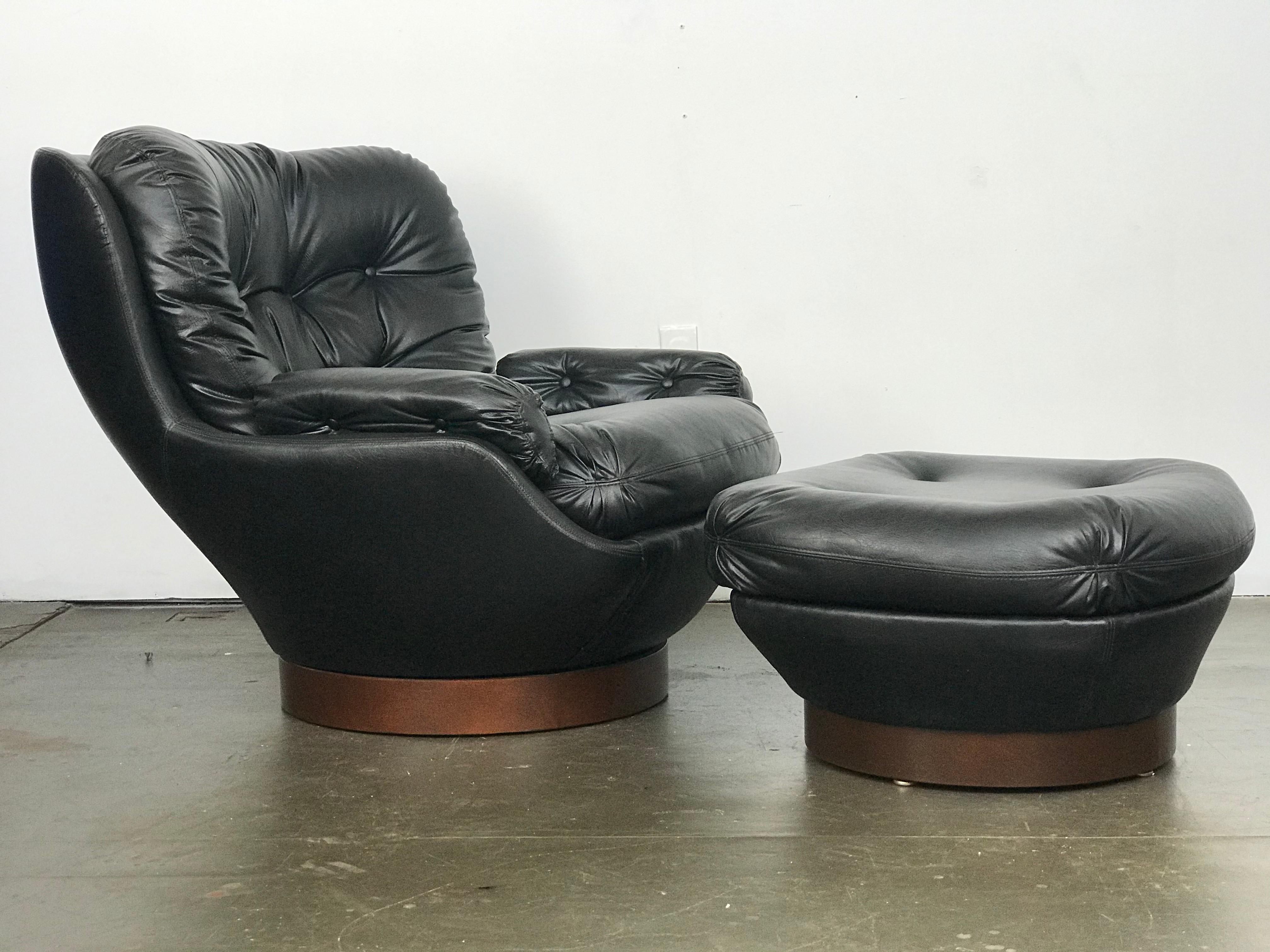 Excellent Mid-Century Modern swivel deep lounge chair and ottoman. I don't think this set was ever used - or it was used lightly. The original Naugahyde is in very nice shape - cushions are nice and comfortable. Walnut bases are clean. Chair swivels