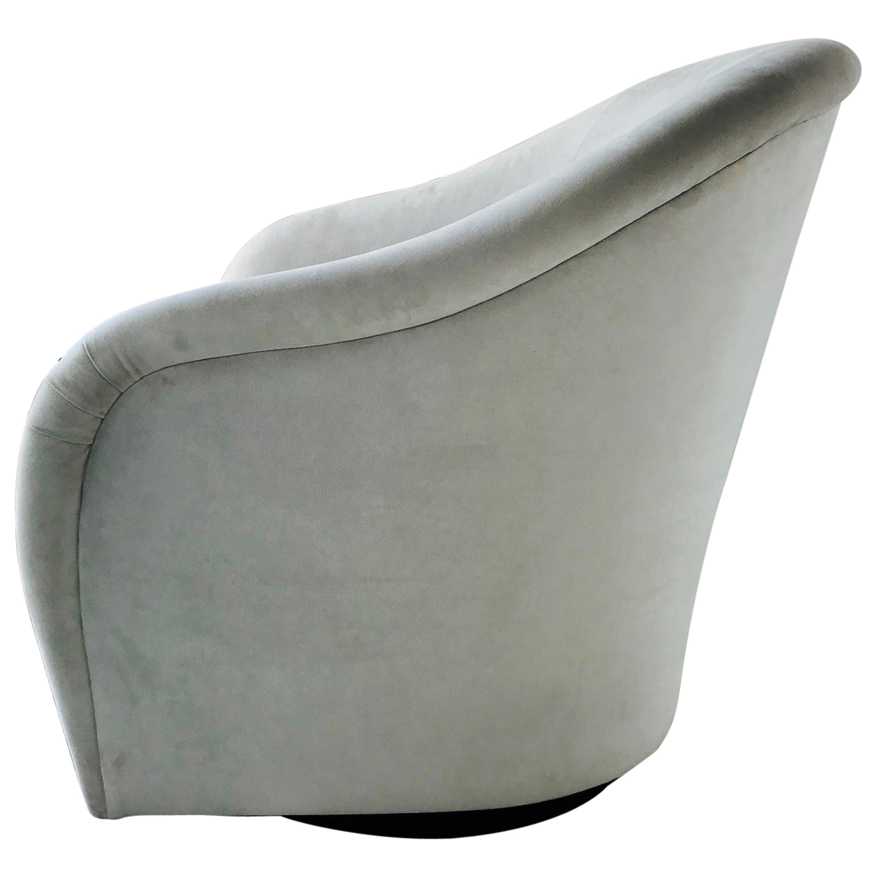 Gorgeous Mid-Century Modern lounge chair with swivel base design. Chair has barrel back form with elegant curved and tapered sides. Newly upholstered in light fine grey velvet with reversible zippered seat cushion and original Interior Crafts label.