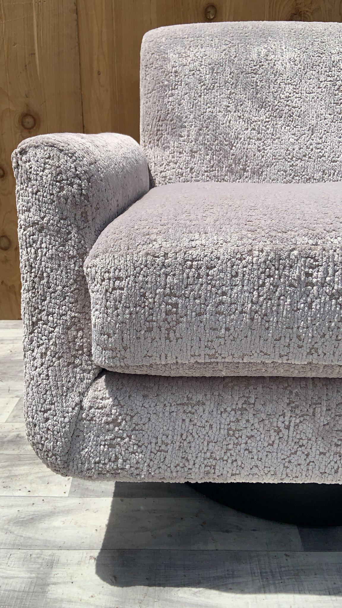 Mid-Century Modern Swivel Lounge Chair Newly Upholstered in a High End Ivory Chenille 

Add another comfortable seat to your living room while making a statement with comfortable accent chair. This stylish piece, upholstered in a soft ivory