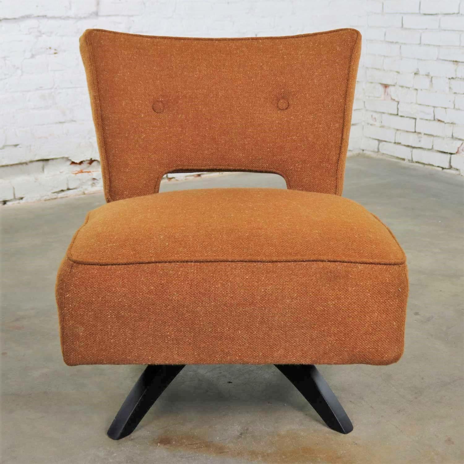 Handsome Mid-Century Modern swivel slipper chair in its original rust colored upholstery and attributed to Kroehler Manufacturing. It is in wonderful vintage condition. The upholstery has been professionally cleaned and the base has been given a