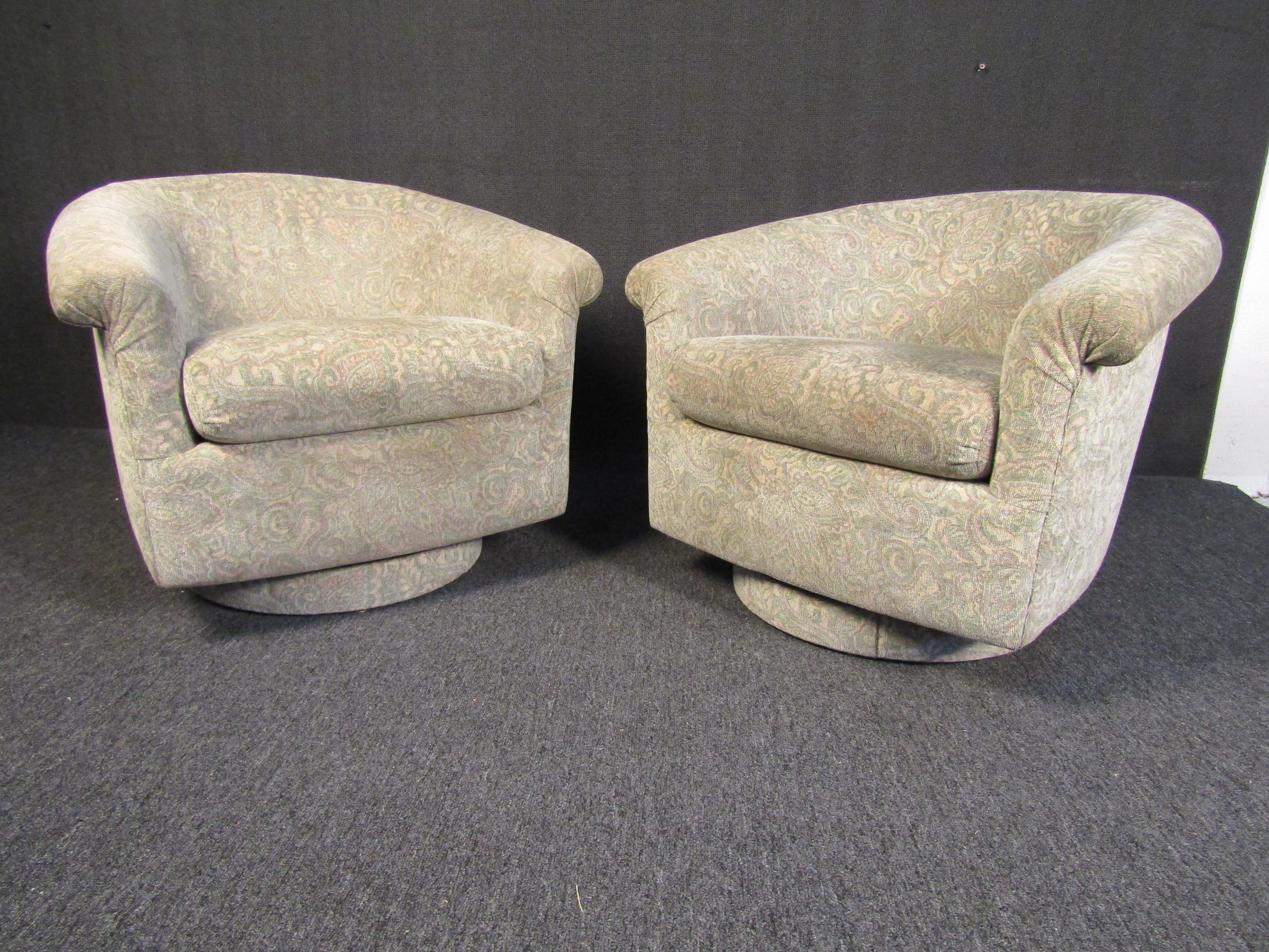 Pair of stylish Mid-Century Modern armchairs that are upholstered in an attractive beige fabric and cushioned for comfortable seating. This pair of vintage chairs is perfect for a living room, office, or any quiet reading corner. Please confirm item