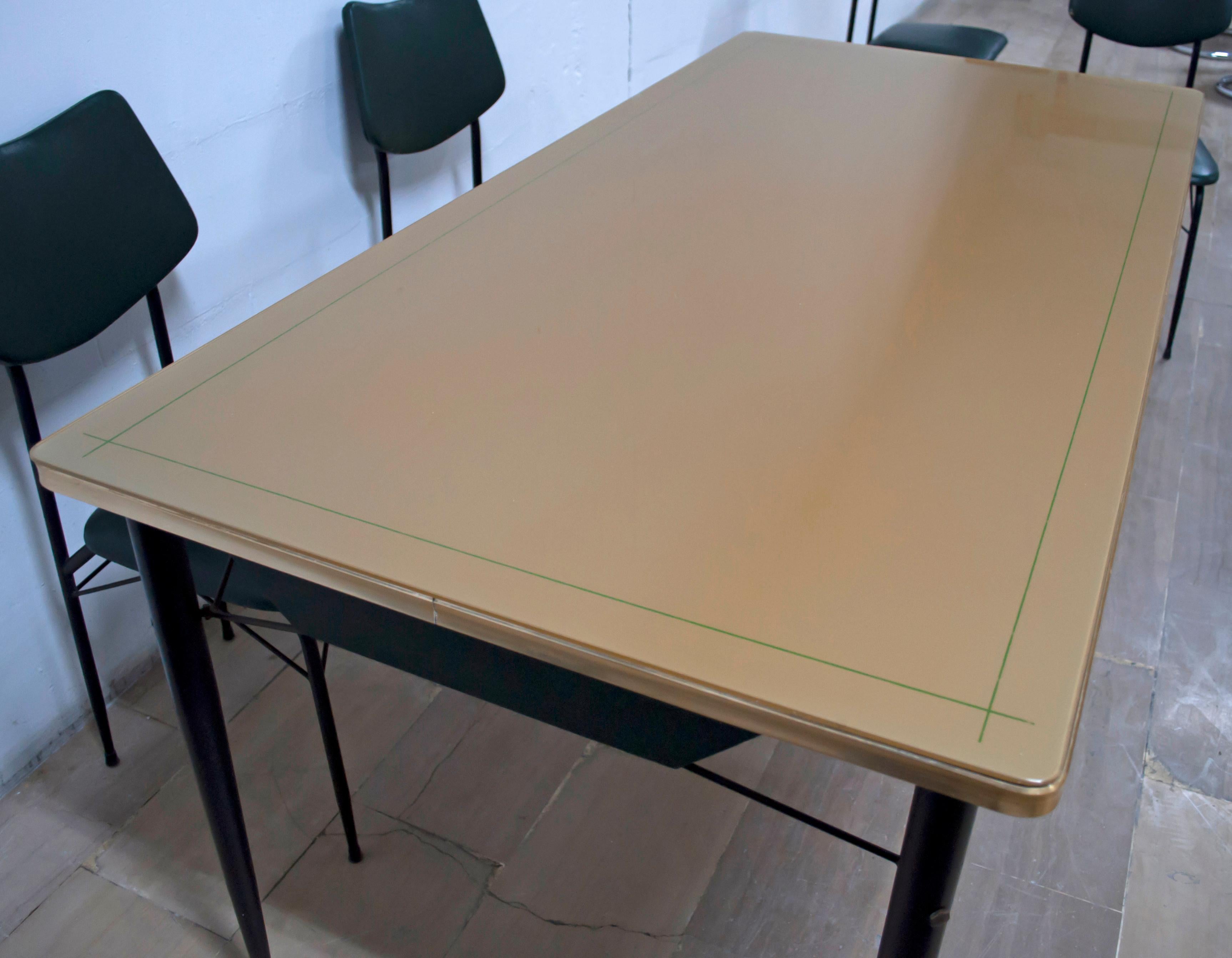 This dining set, consisting of a table and six chairs, was produced in the 1950s, in glass, black iron, and dark green eco-leather.

Dimensions of the chairs: H 88 cm x W 40 cm x D cm 43 x S cm 45

