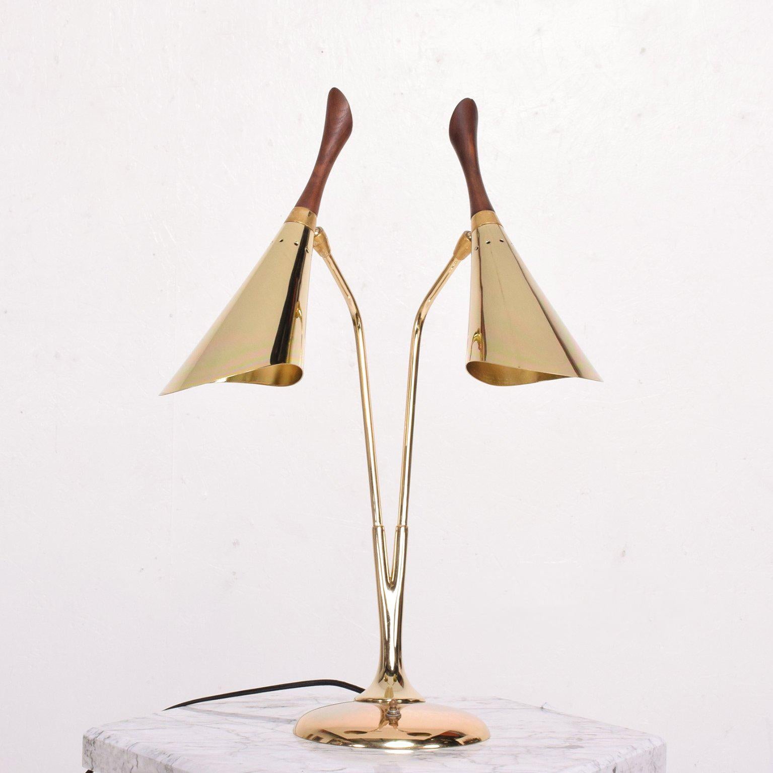For your consideration a Mid-Century Modern table or desk lamp with double shade. 

Unusual double cone with beautiful sculptural shape. 

Excellent condition. Rewired. 

New brass plated finish with walnut inserts in top. Electrical cord in