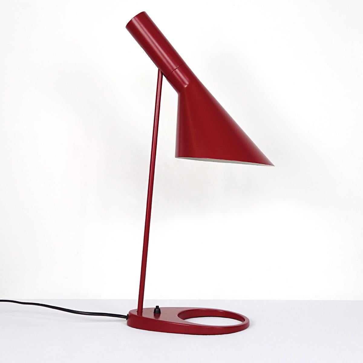 This table lamp was designed in 1957 but still looks as fresh as a summer breeze. It was called AJ, the initials of its designer Arne Jacobsen. 
It was made in Denmark by Louis Poulsen.
The lamp was designed, among other lighting fixtures, for the