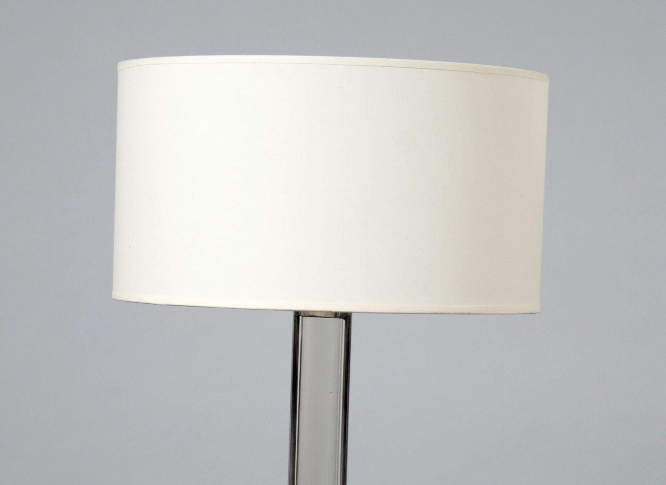 Chrome table lamp with encased glass stem attributed to Jacques Adnet. This is a simple good quality table or desk lamp that would fit well into a contemporary or more traditional decorative scheme.

 
 
 
  