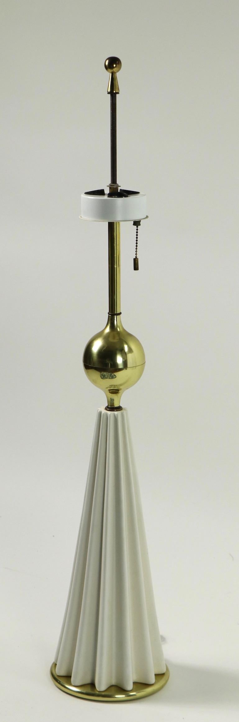 Stylish architectural table lamp designed by Gerald Thurston. The lamp has a white ribbed conical base with a brass decorative ball shaft. The lamp accepts three standard size screw in bulbs, each can be lit individually or together. Working, clean