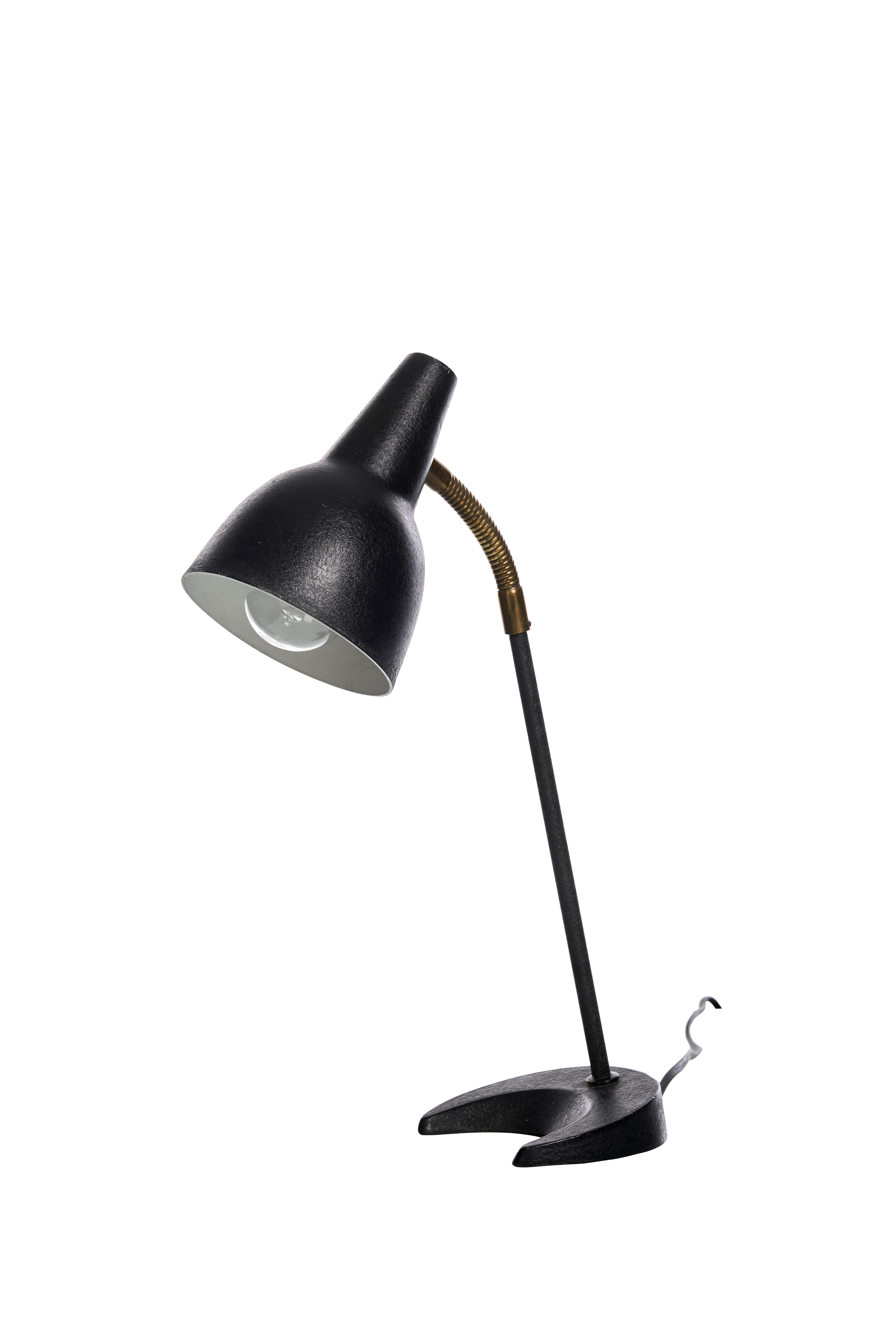 Il s'agit d'une lampe de table moderne du milieu du siècle par AT&T, fabriquée en Norvège dans les années 1950. Elle se compose d'un abat-jour conique noir mat avec une finition légèrement texturée, monté sur une tige mince et droite. La tige de la