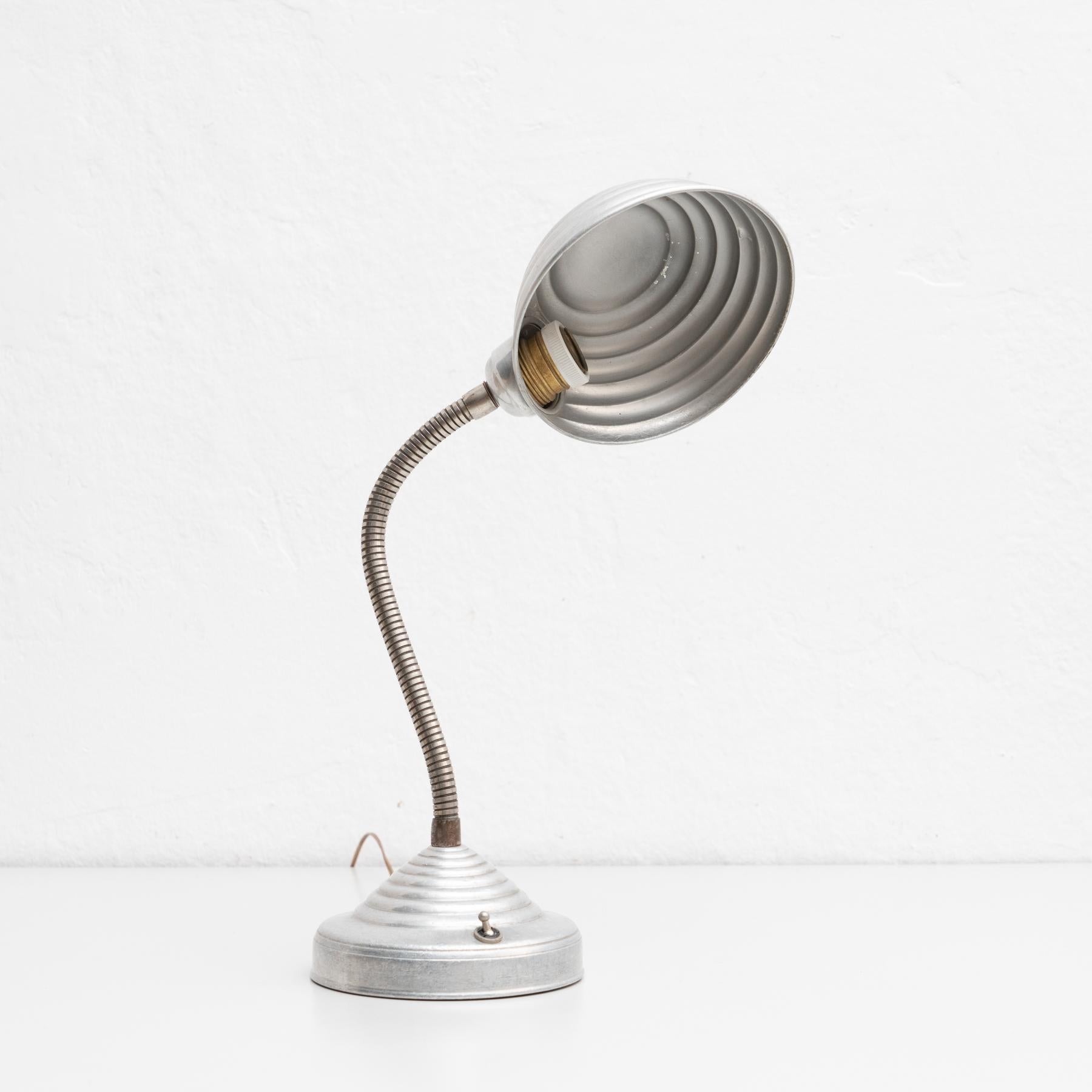 Mid-Century Modern table lamp.

By unknown manufacturer from France, circa 1960.

In original condition, with minor wear consistent with age and use, preserving a beautiful patina.

Material:
Metal

Electrification not tested. Wired for Europe.