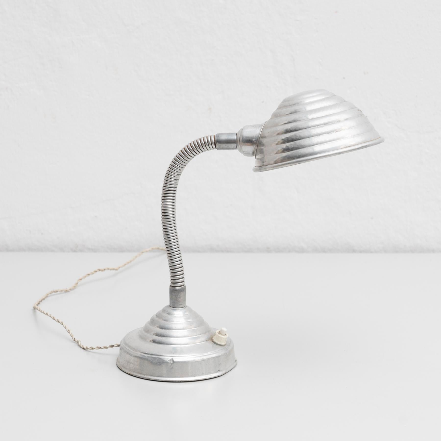 Mid-Century Modern table lamp.

By unknown manufacturer from France, circa 1960.

In original condition, with minor wear consistent with age and use, preserving a beautiful patina.

Material:
Metal.
 