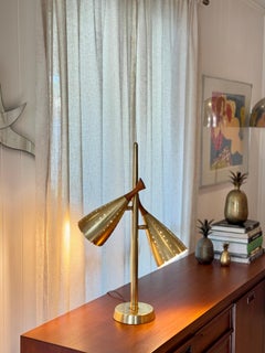 mid century modern table lamp featuring dual brass cone shades and teak accents