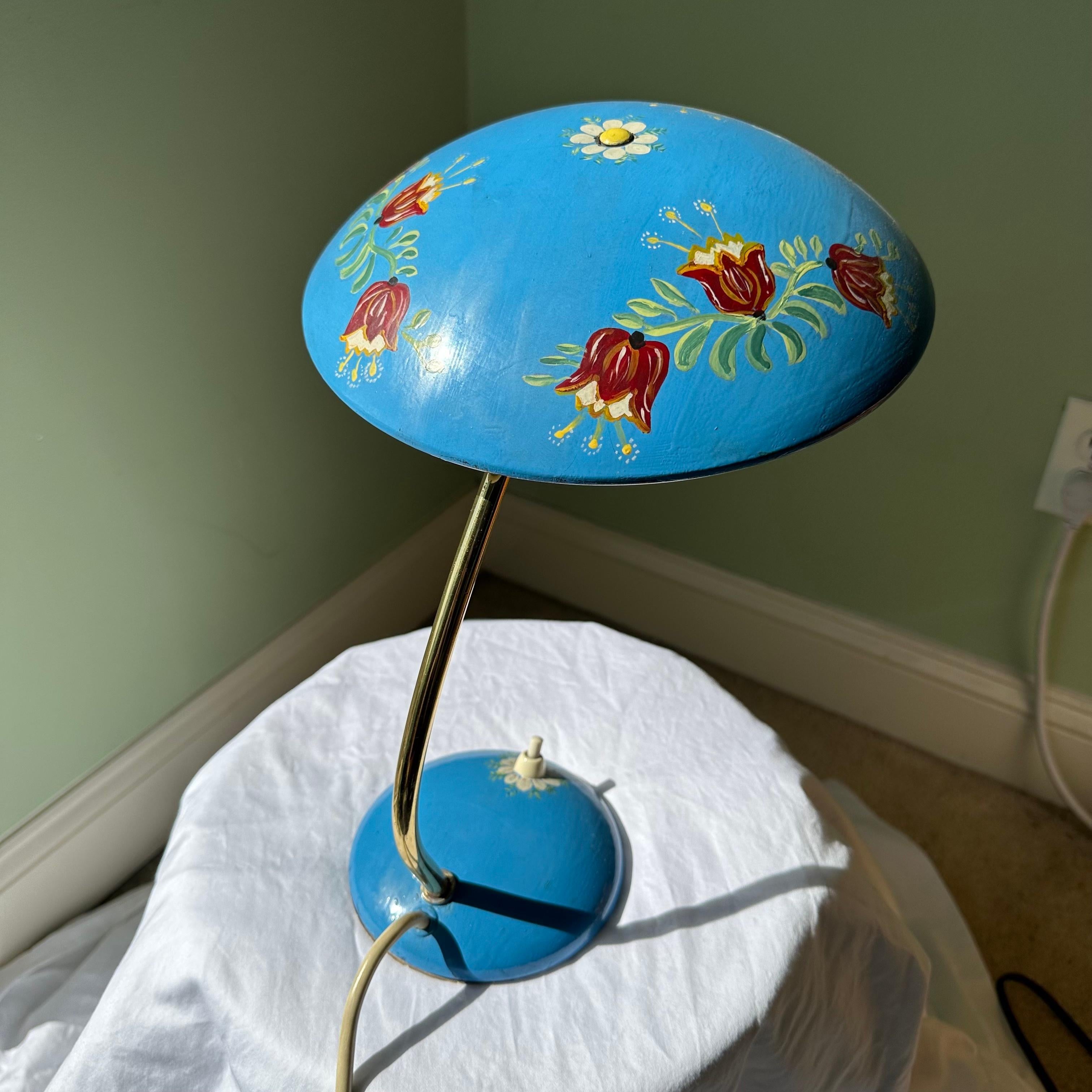 Absolutely darling and one of a kind vintage mid century table lamp or desk lamp with hand painted floral details. A unique, hand painted, folk art version of the Christian Dell for Kaiser Idell Model 6782 lamp. Satin brass metal with saucer pr UFO