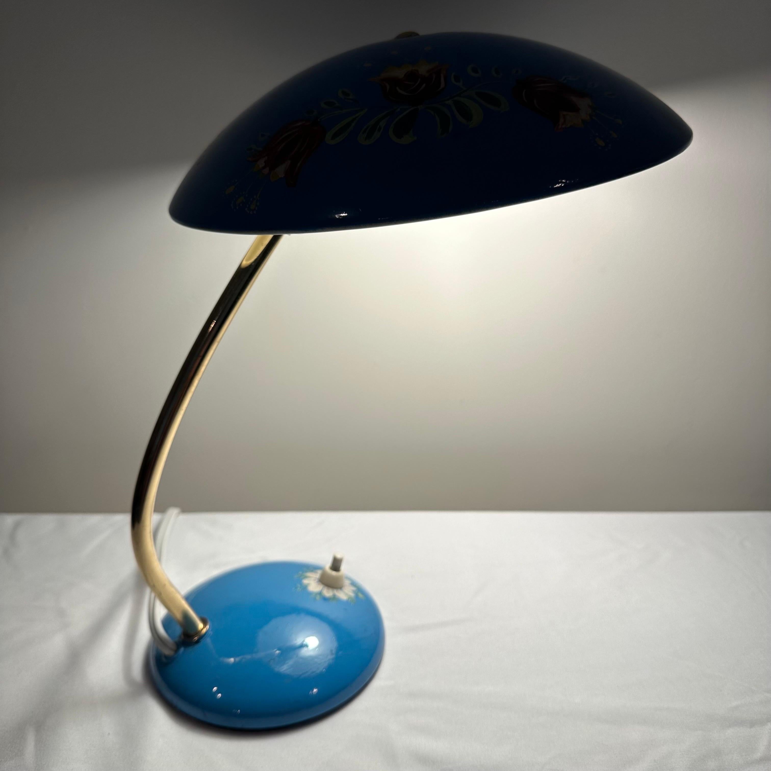 Absolutely darling and one of a kind vintage mid century table lamp or desk lamp with hand painted floral details. A unique, hand painted, folk art version of the Christian Dell for Kaiser Idell Model 6782 lamp. Satin brass metal with saucer pr UFO