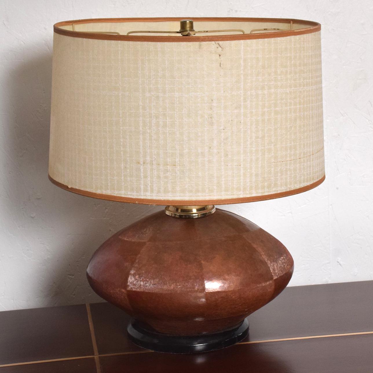 For your consideration a unique table lamp with a texturized and patinated cooper body mounted in a wood base (painted in black) and brass hardware. 

Lamp has been tested and currently working. Lampshade not included. Lamp has the original