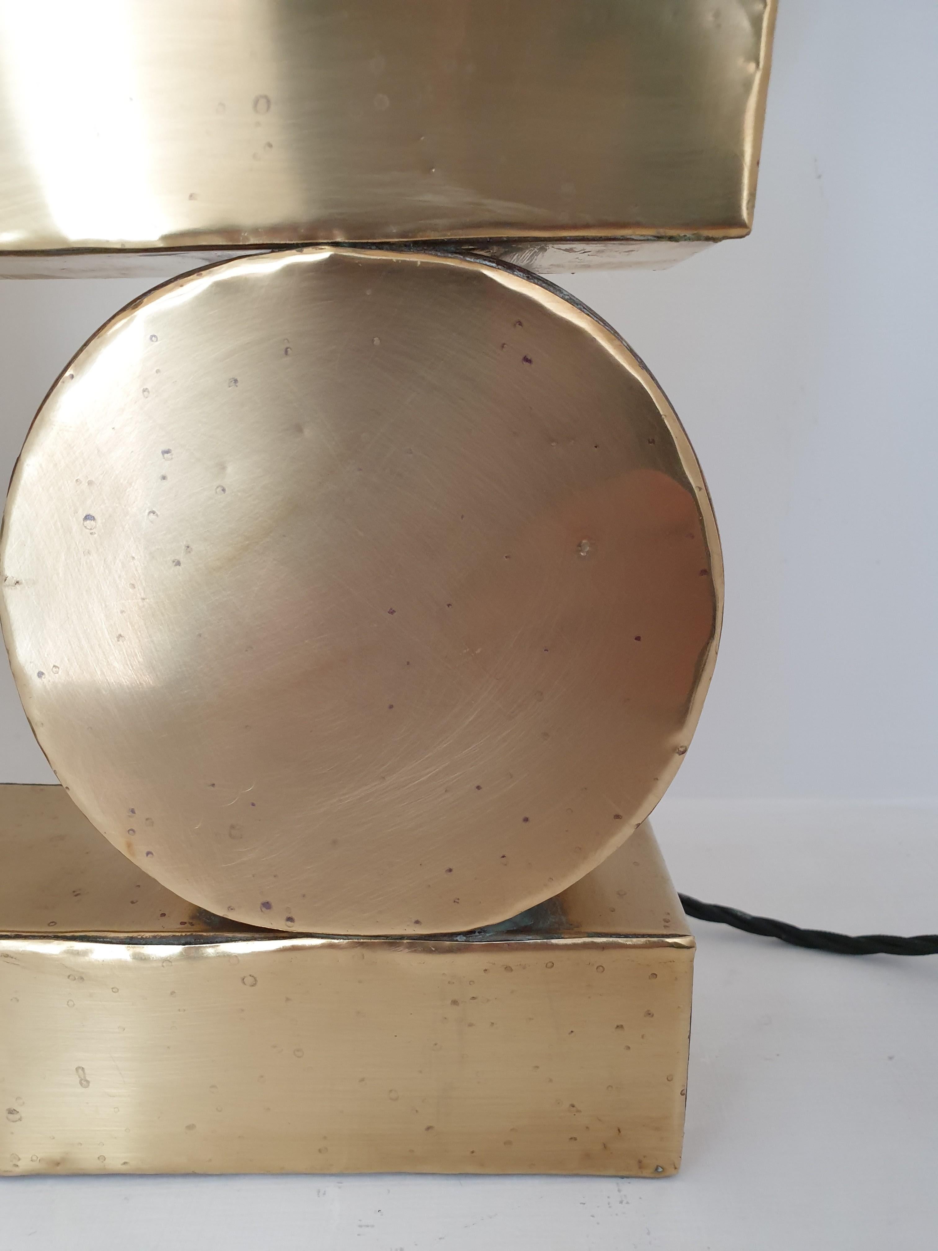 Unusual brass table lamp composed of thin brass sheets welded to a form. In the manner of Pierre Cardin. Please note there are a few areas that have small dents as the brass facing is a soft material.