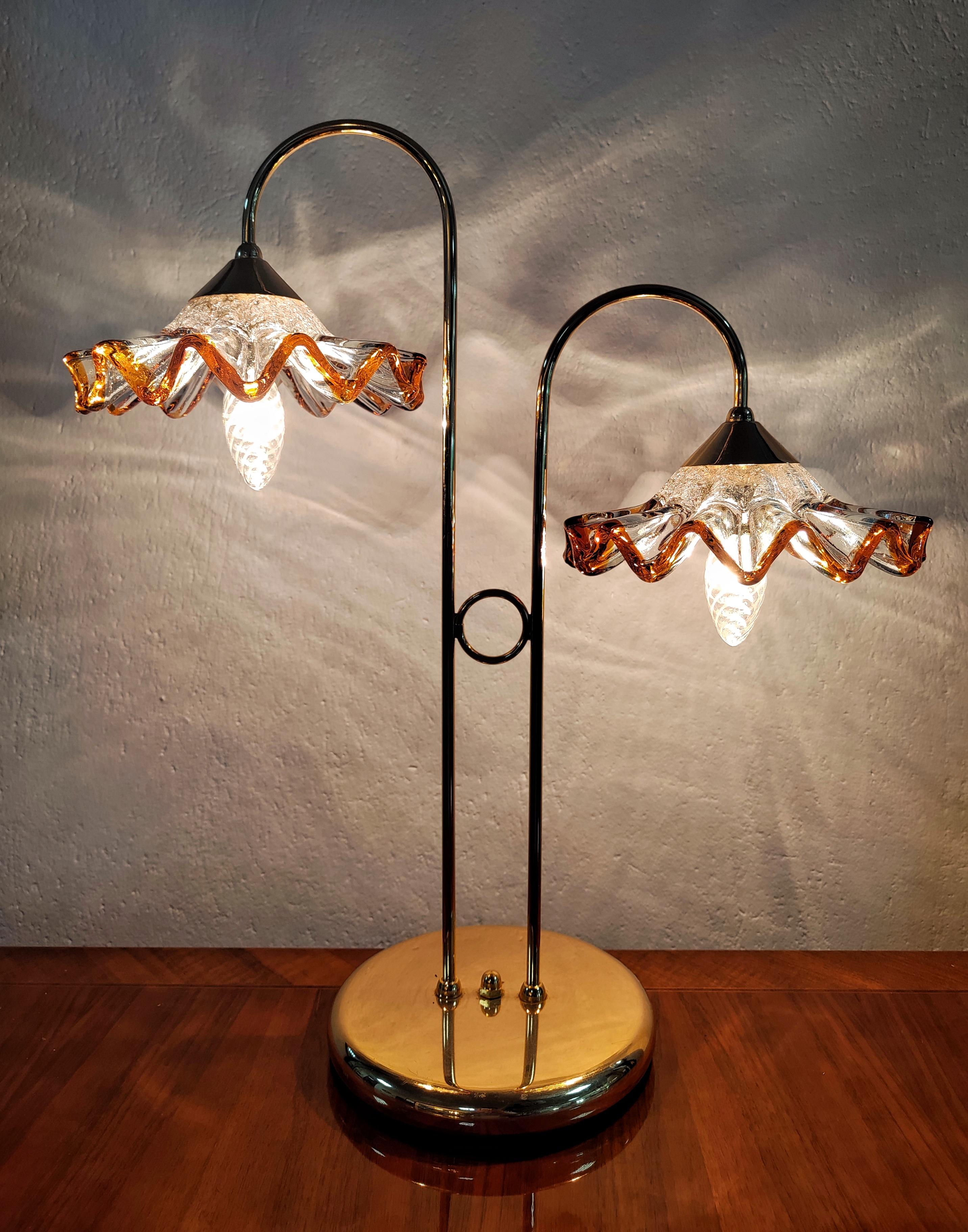 Rare and Attractive Mid Century Modern Dual Table Lamp done in brass, with clear and amber Murano glass floral shades by AV Mazzega. Made in Italy in 1970s.

Nearly excellent vintage condition with barely any signs of use and time. Glass shades are