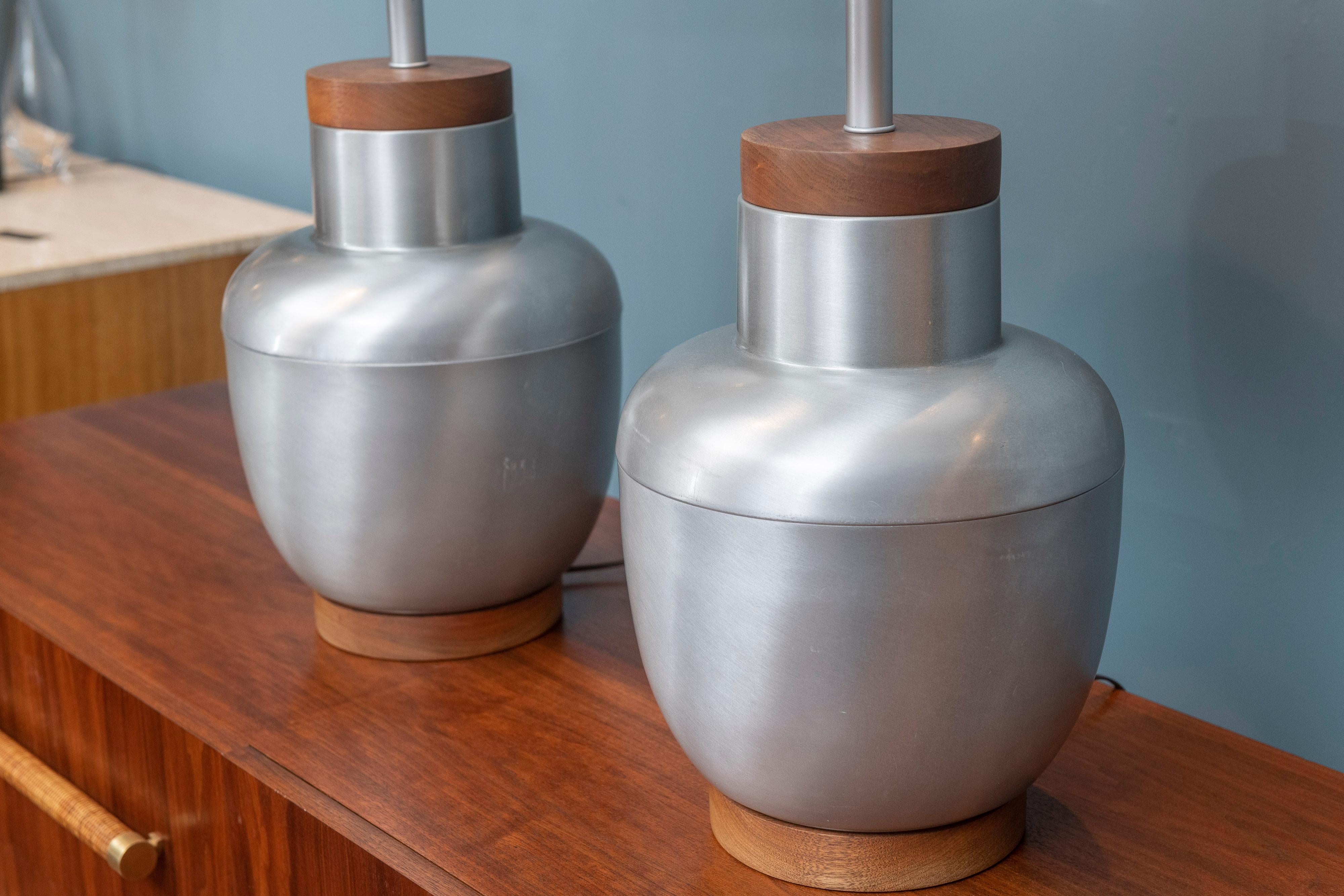 Mid-Century Modern spun aluminum decorative table lamps with walnut bases and tops just newly rewired and ready to install. The lamps are American made of high quality by an unknown manufacturer and show minimal signs of age and use including scuffs