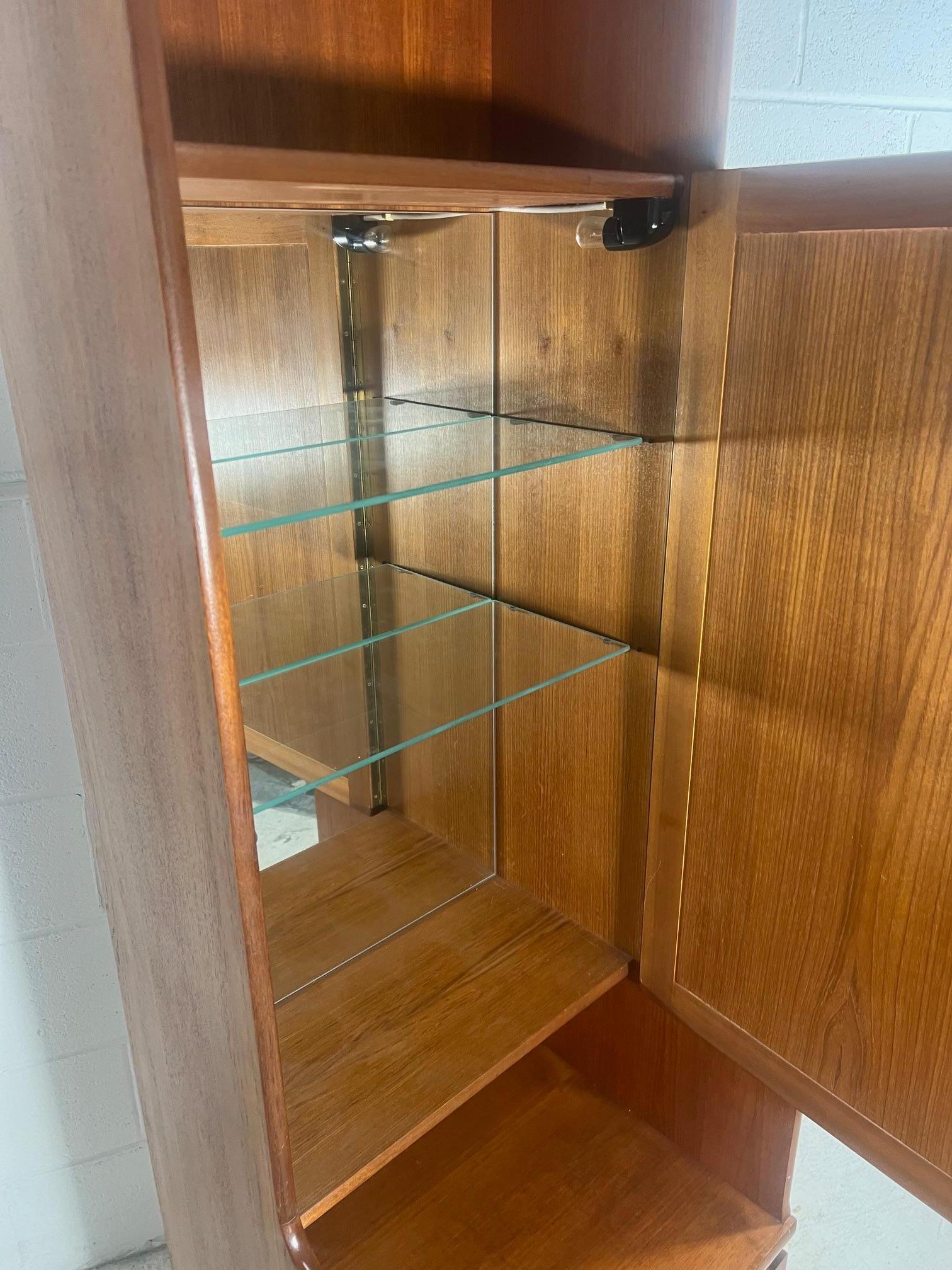 Tall and narrow teak drinks cabinet with bar. Comes with lock and key.

Very good condition. Minor marks. There is a light at the top. Light bulb is missing and it needs to be rewired for US use.

Dimensions: L x D x H

20.25