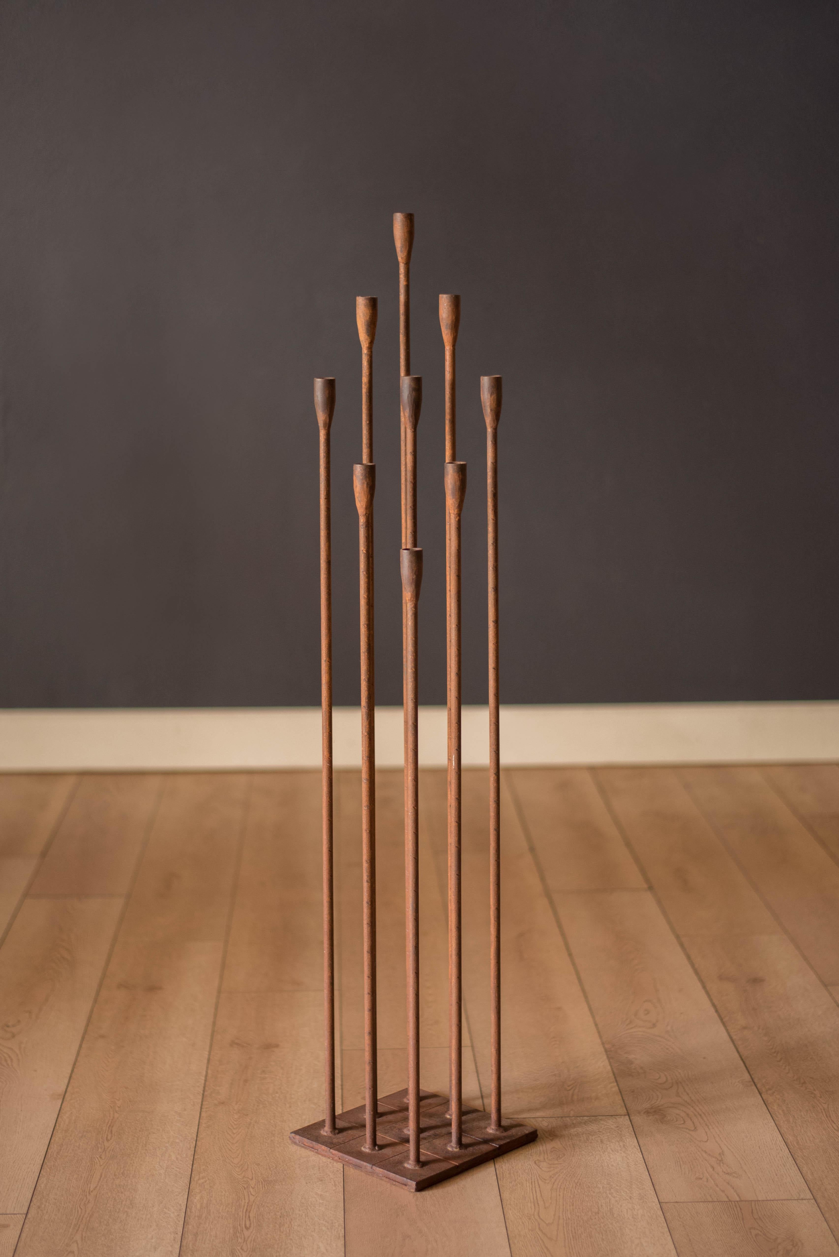 Vintage tall floor standing candelabra circa 1960's. This decorative statement piece adds depth and character to any space constructed of weighted cast iron. Displays plenty of patina and vintage charm including nine candle holders that fit 3/4