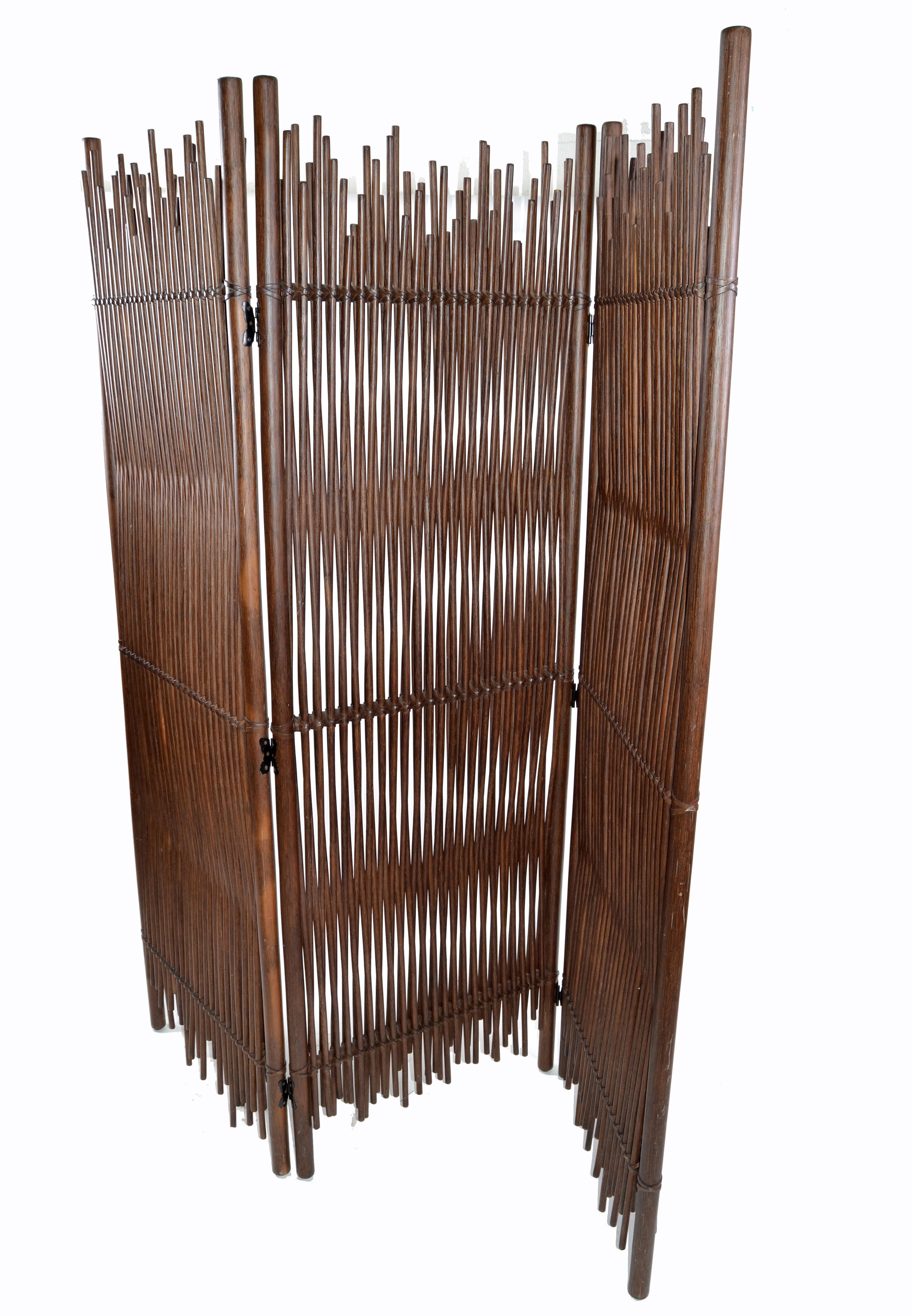 Mid-Century Modern tall three double wall-panel solid bamboo wood room divider in dark brown finish, comes from Italy.
Heavy and very well crafted with leather cross bindings and butterfly hinges.
Dimensions closed:
Width 24 inches, depth 6 inches,