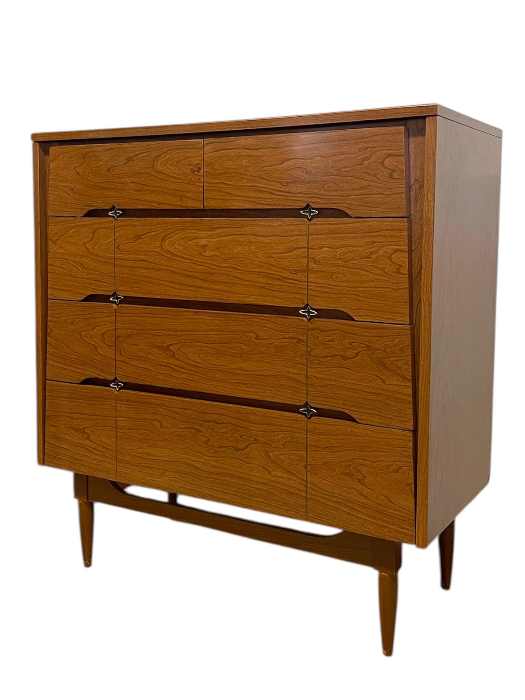  Mid-century modern tallboy dresser crafted by Kroehler as part of their Custom Crafter line, circa 1960s. This piece features a warm walnut-toned finish with striking wood grain patterns across the drawer fronts. The design includes six spacious