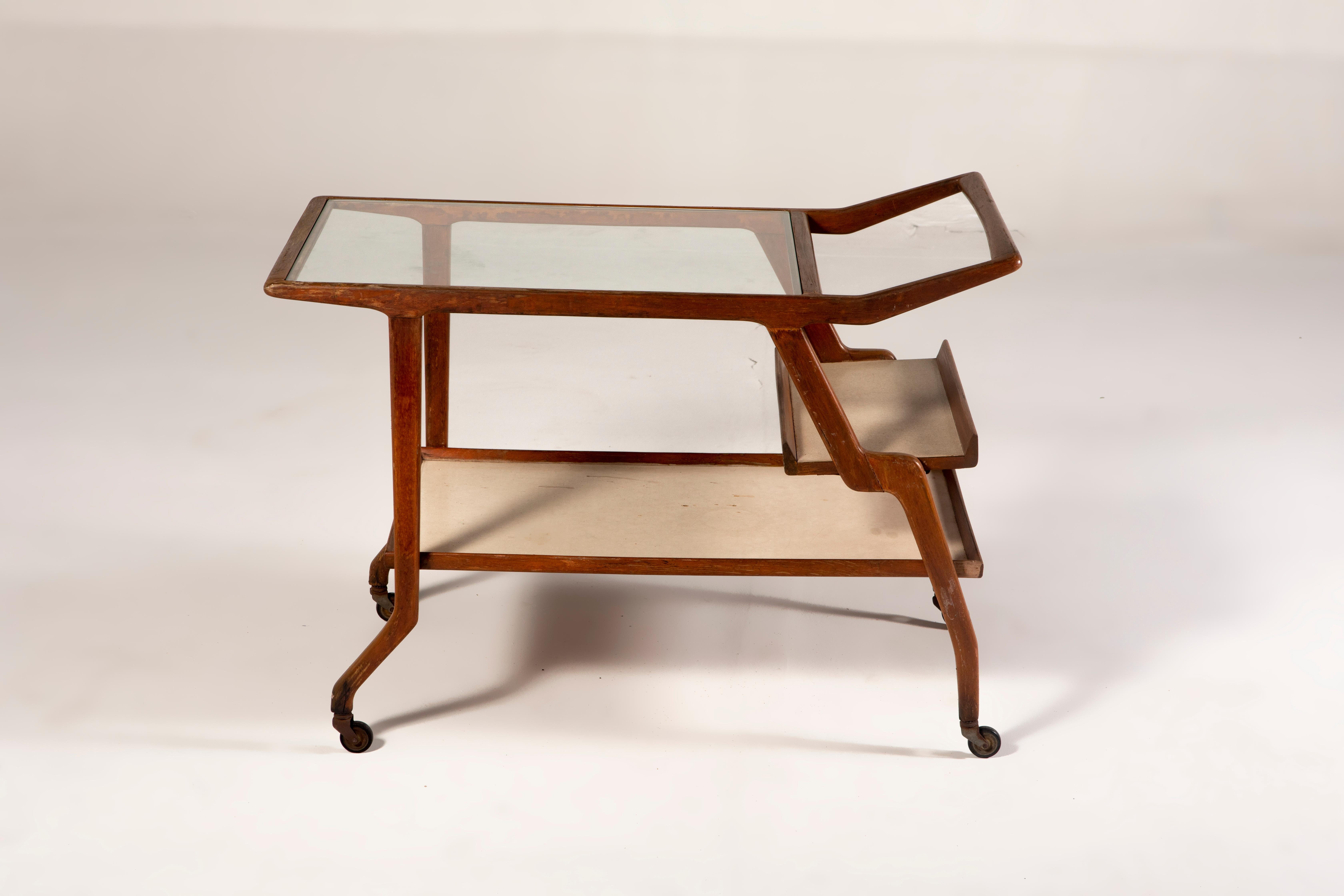 Mid-Century Modern Tea Cart by Brazilian Designer, 1960s

Mid-Century Brazilian Tea Cart by Unattributed Brazilian Designer, manufactured circa 1960.
The tea cart has 3 levels, the first with a formica top, and the last with a glass top, while the